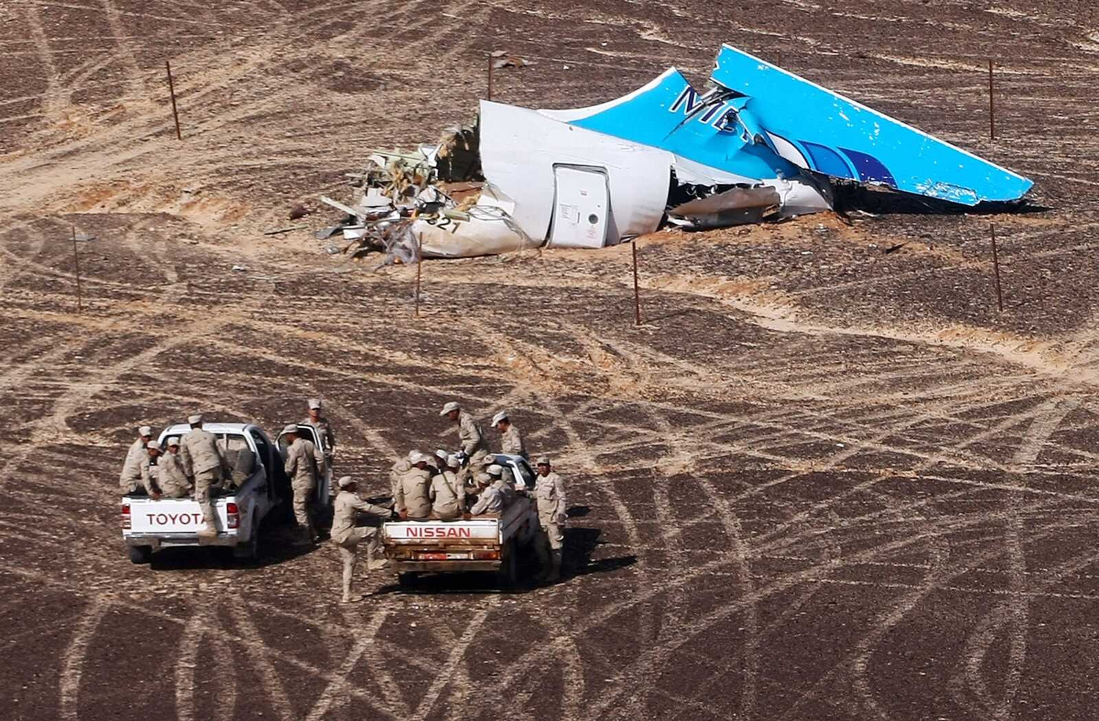 Egyptian soldiers on cars approach a plane's tail at the wreckage of a passenger jet bound for St. Petersburg in Russia that crashed last week in Hassana, Egypt. (Maxim Grigoriev ~ Russian Ministry for Emergency Situations)