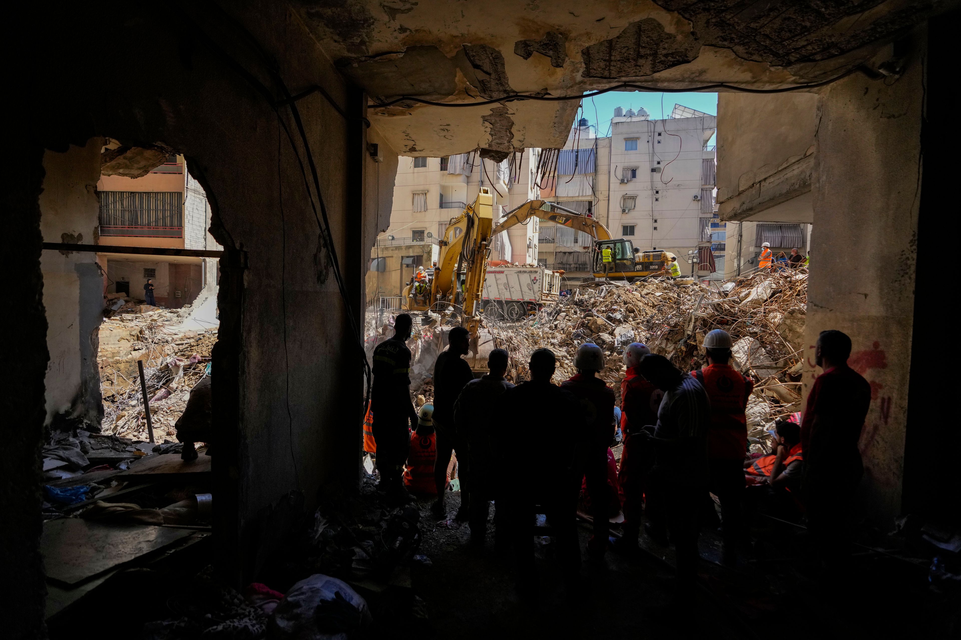 FILE - Emergency workers use excavators to clear the rubble at the site of Friday's Israeli strike in Beirut's southern suburbs, Lebanon, Monday, Sept. 23, 2024. (AP Photo/Hassan Ammar)