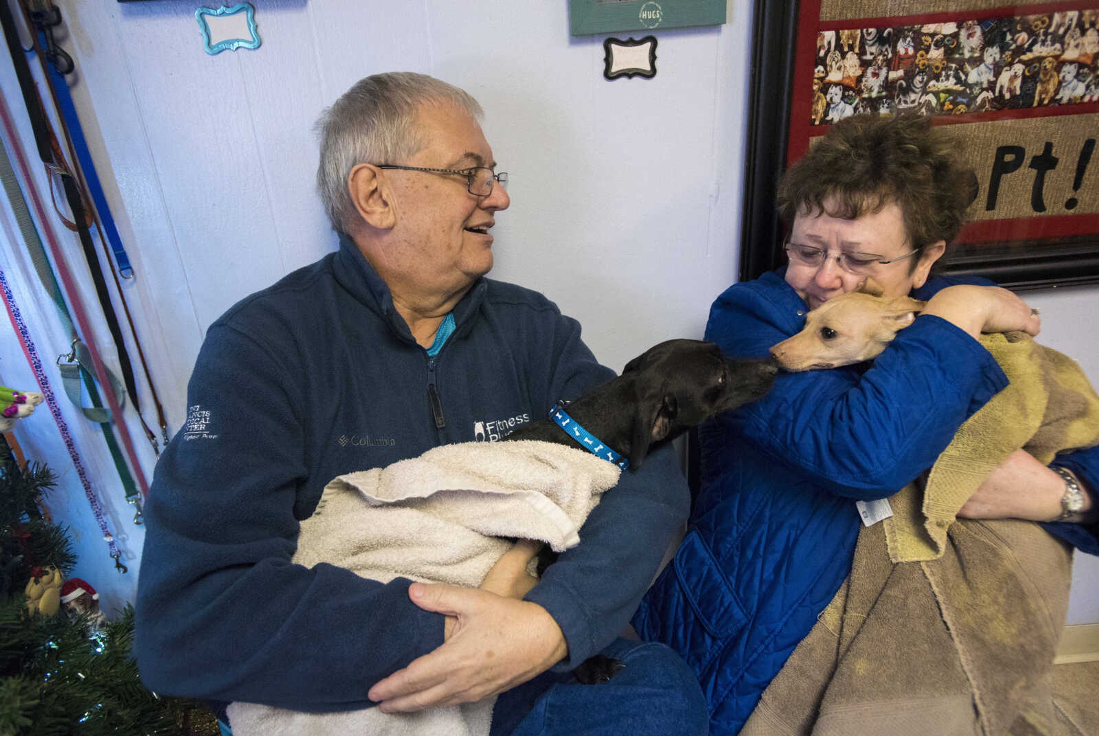 Wesley Mangels and his wife Linda Mangels hold dogs at the 40th anniversary of the Humane Society of Southeast Missouri Saturday, Dec. 16 , 2017 in Cape Girardeau.