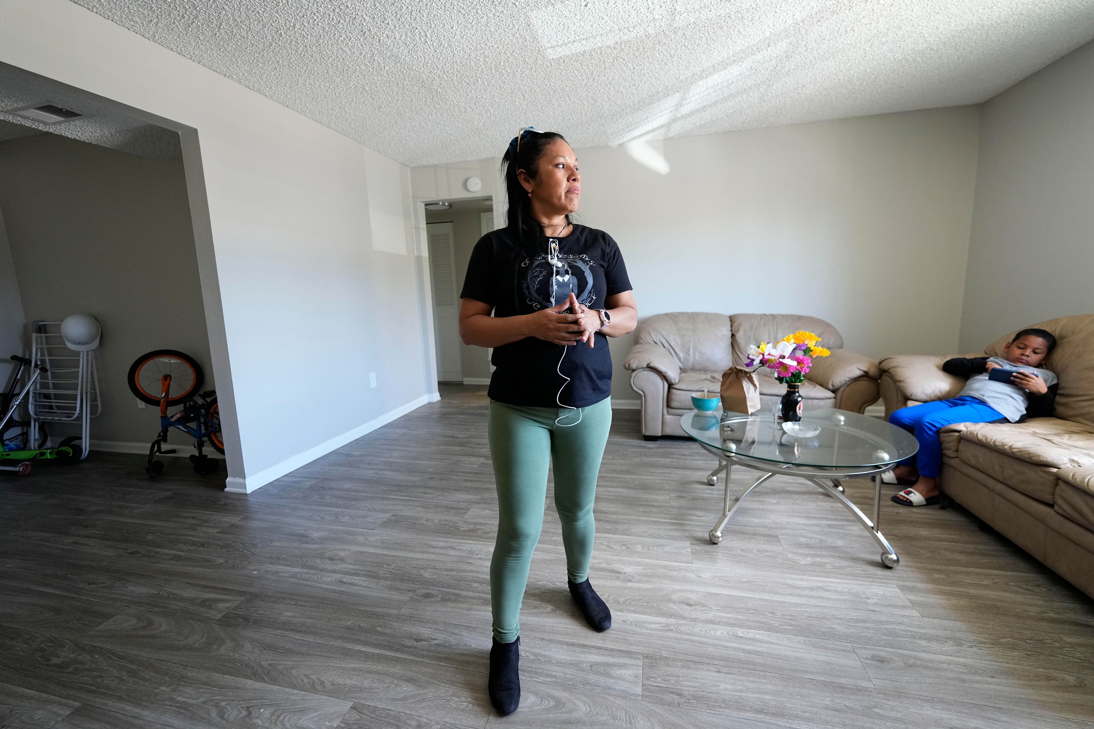 María Ángel Torres looks out the window during an interview at her apartment Friday, May 18, 2024, in Aurora, Colorado. (AP Photo/Jack Dempsey)