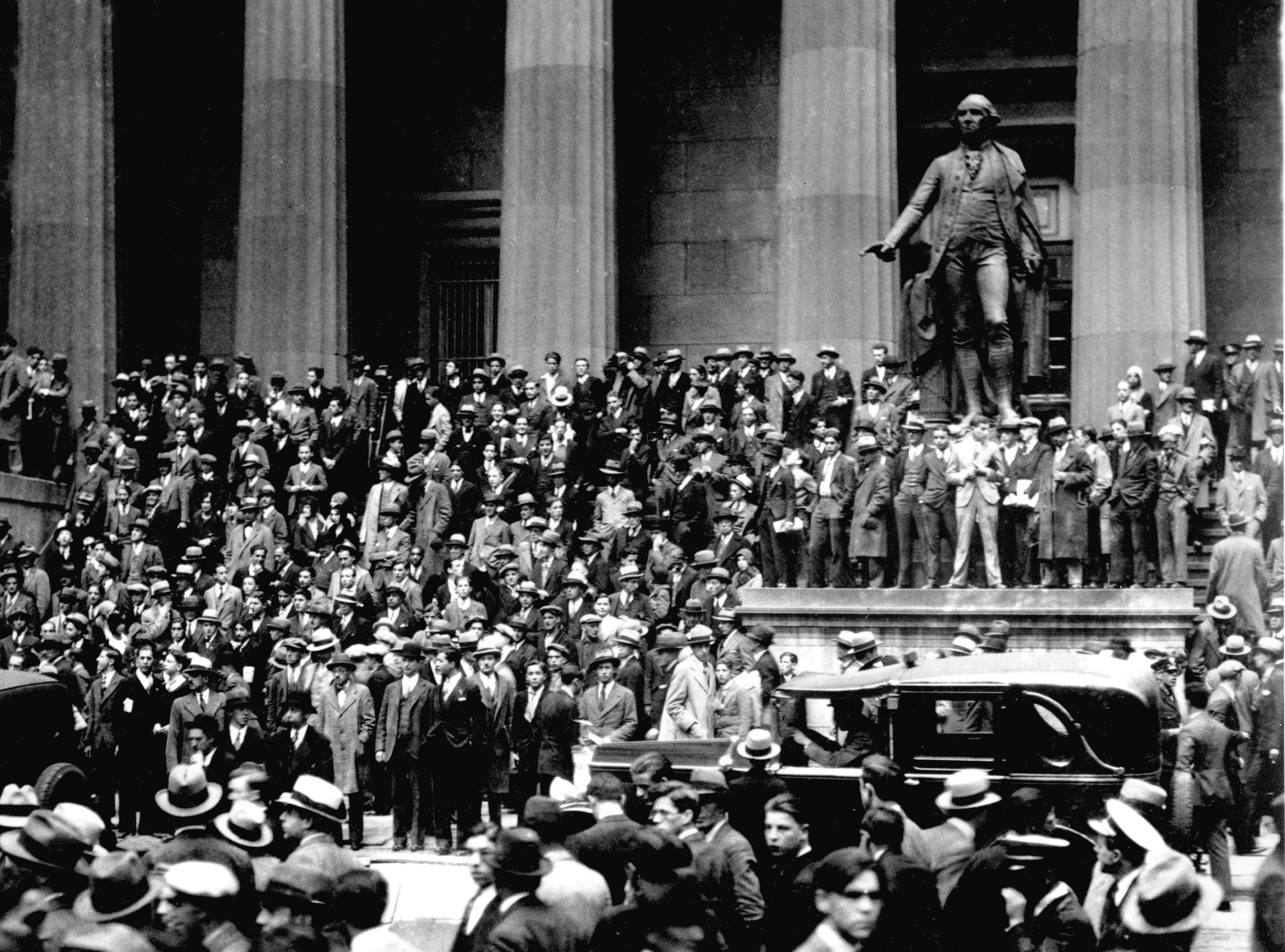 In this Oct. 24, 1929 file photo, people gather on the steps of Federal Hall across from the New York Stock Exchange in New York on "Black Thursday." 