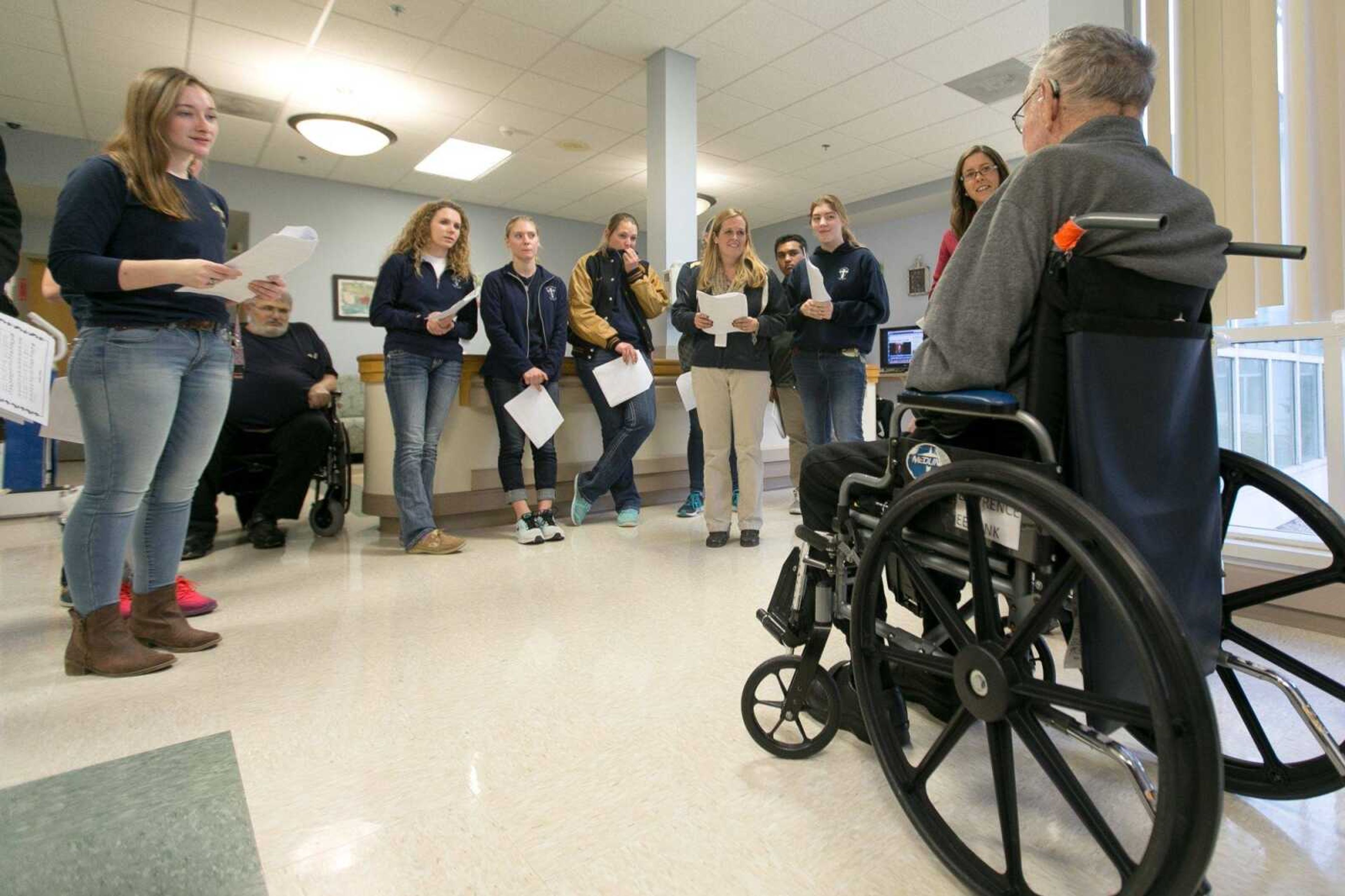 The Saxony Lutheran High School Beta Club listens to Lawrence Eeftink talk about his favorite Christmas carols during a trip to the Missouri Veterans Home to carol Dec. 8 in Cape Girardeau. (Glenn Landberg)