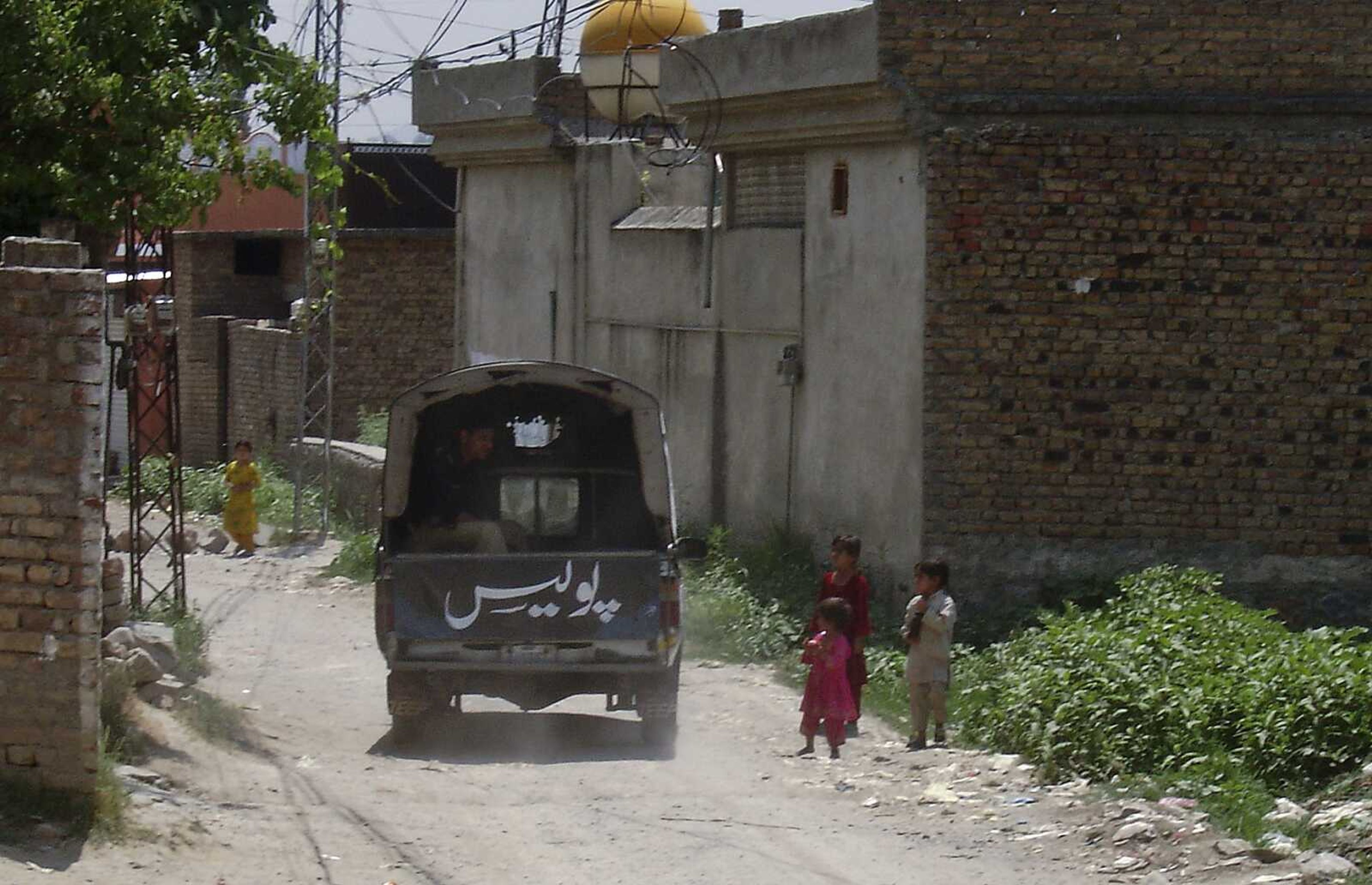 A police vehicle patrols a street on Wednesday, June 15, 2011, near to the house where al-Qaida leader Osama bin Laden was caught and killed in Abbottabad, Pakistan on May 2, 2011. The Pakistani army denied that one of its majors was among a group of Pakistanis who Western officials say were arrested for feeding the CIA information before the American raid that killed Osama bin Laden. (AP Photo/Aqeel Ahmed)(AP Photo/Aqeel Ahmed)