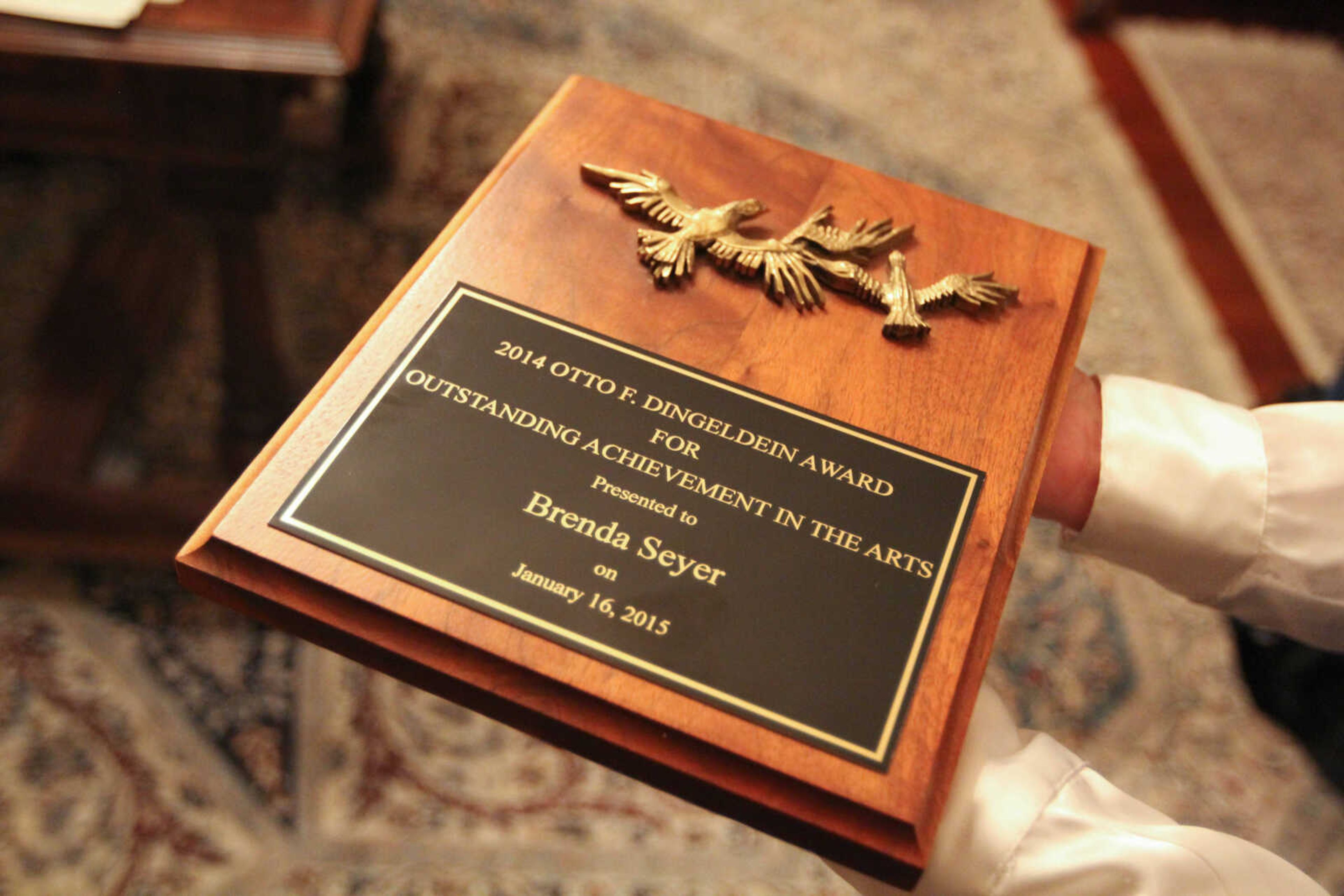 GLENN LANDBERG ~ glandberg@semissourian.com

Brenda S. Seyer holds the Otto F. Dingeldein award after winning it during the second annual Dingeldein Gala at the Oliver-Leming House Friday, Jan. 16, 2014.