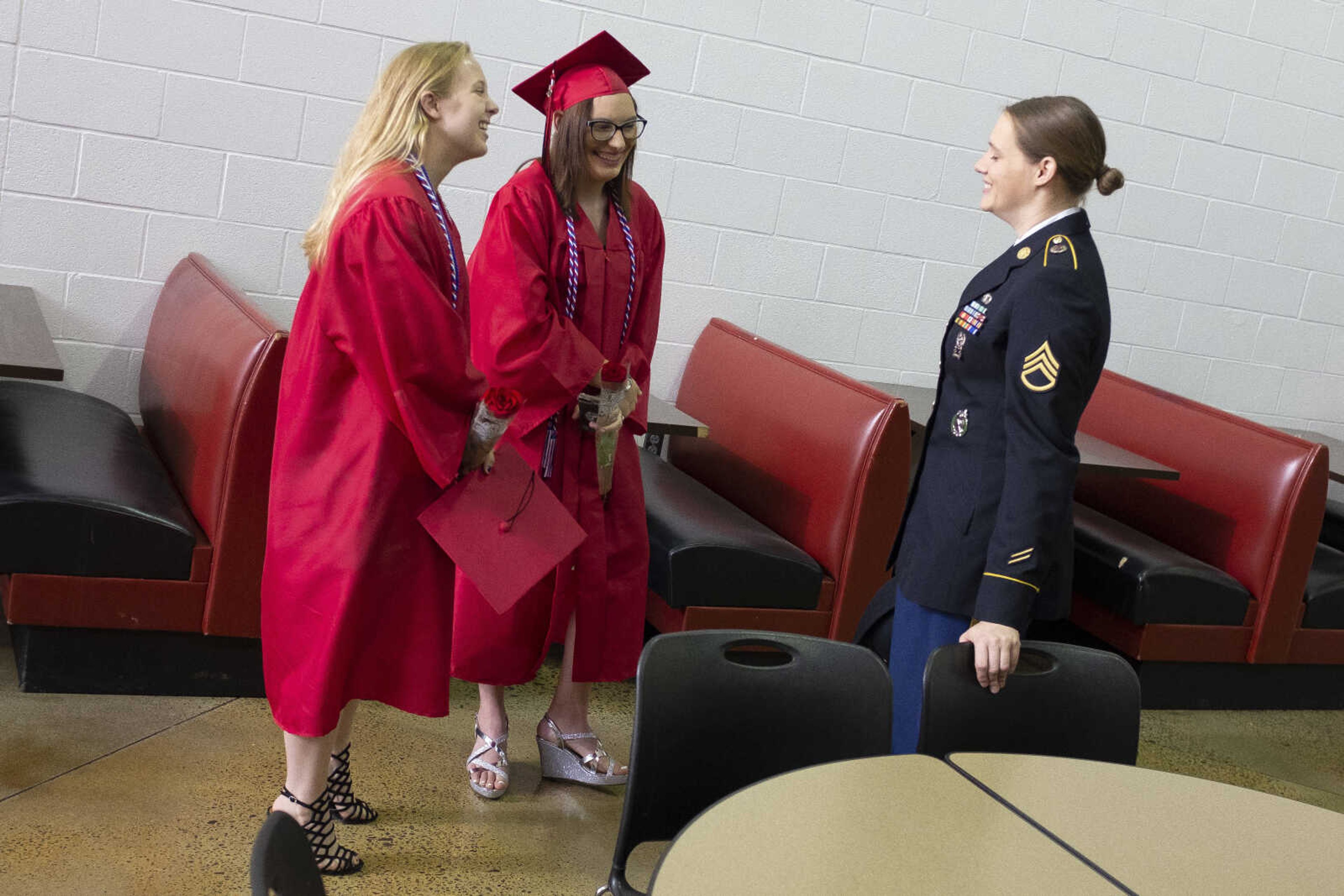 Jackson High School graduates Erin Taylor Huff (left) and Amber Marie Lowes (middle) converse with Army recruiter and Staff Sgt. Brooke Schoenbeck prior to an in-person military graduation ceremony Friday, May 22, 2020, at Jackson High School.