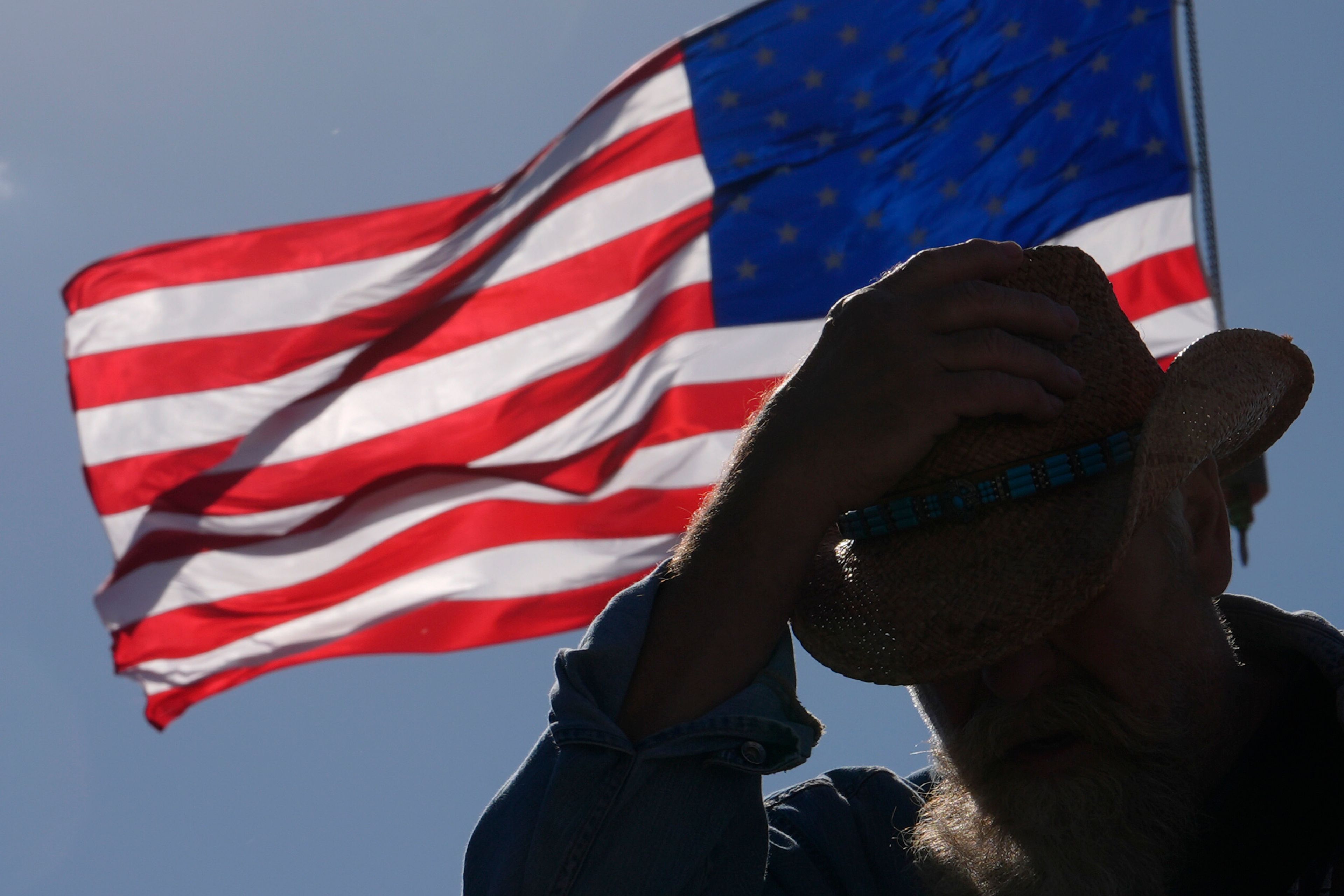 An attendee waits for Republican presidential nominee former President Donald Trump to speak during a campaign rally at Dodge County Airport, Sunday, Oct. 6, 2024, in Juneau, Wis. (AP Photo/Julia Demaree Nikhinson)