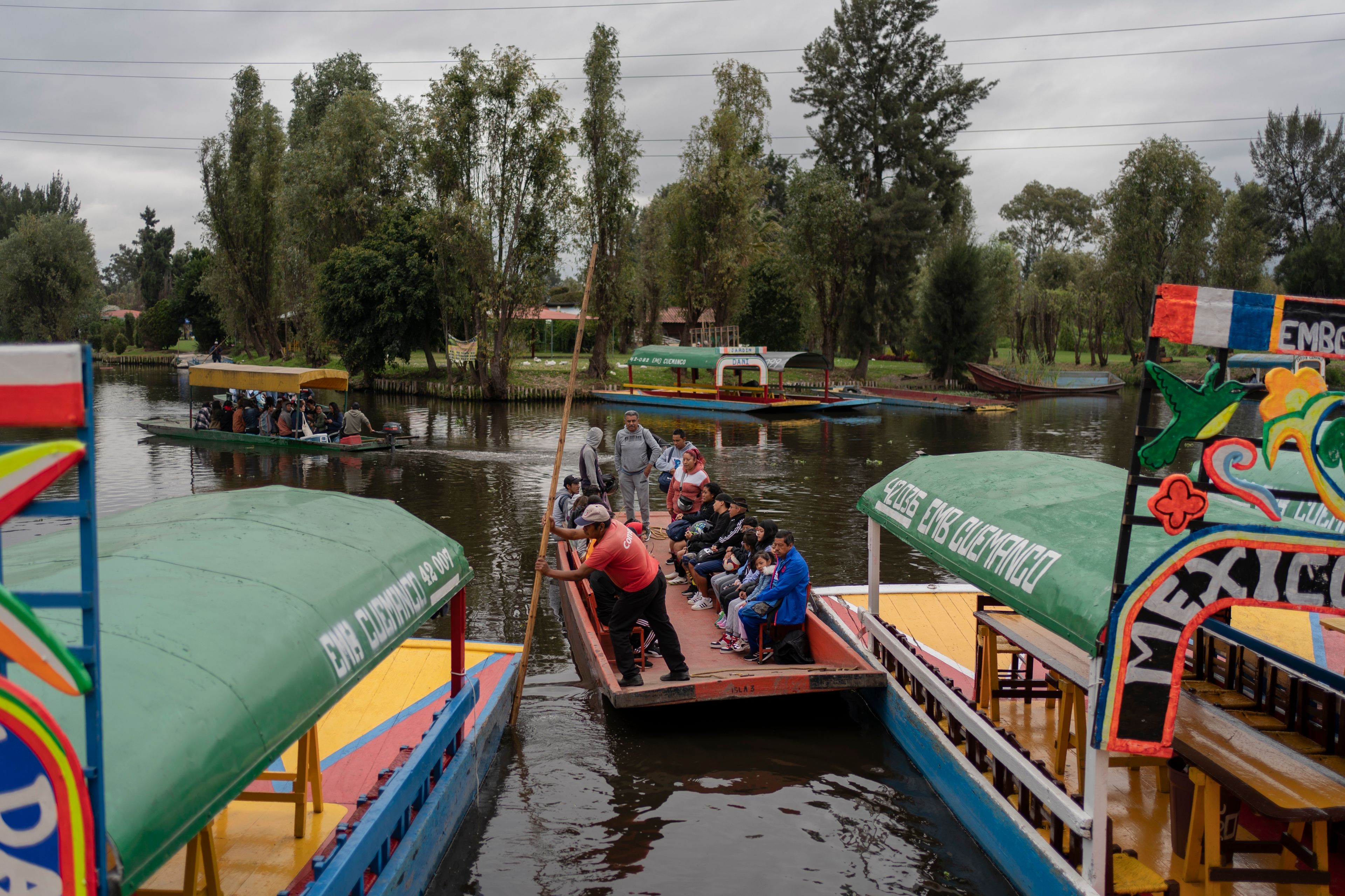 Amateur soccer players and families travel in a traditional canoe in the Xochimilco borough of Mexico City, on Sunday, October 20, 2024. (AP Photo/Felix Marquez)