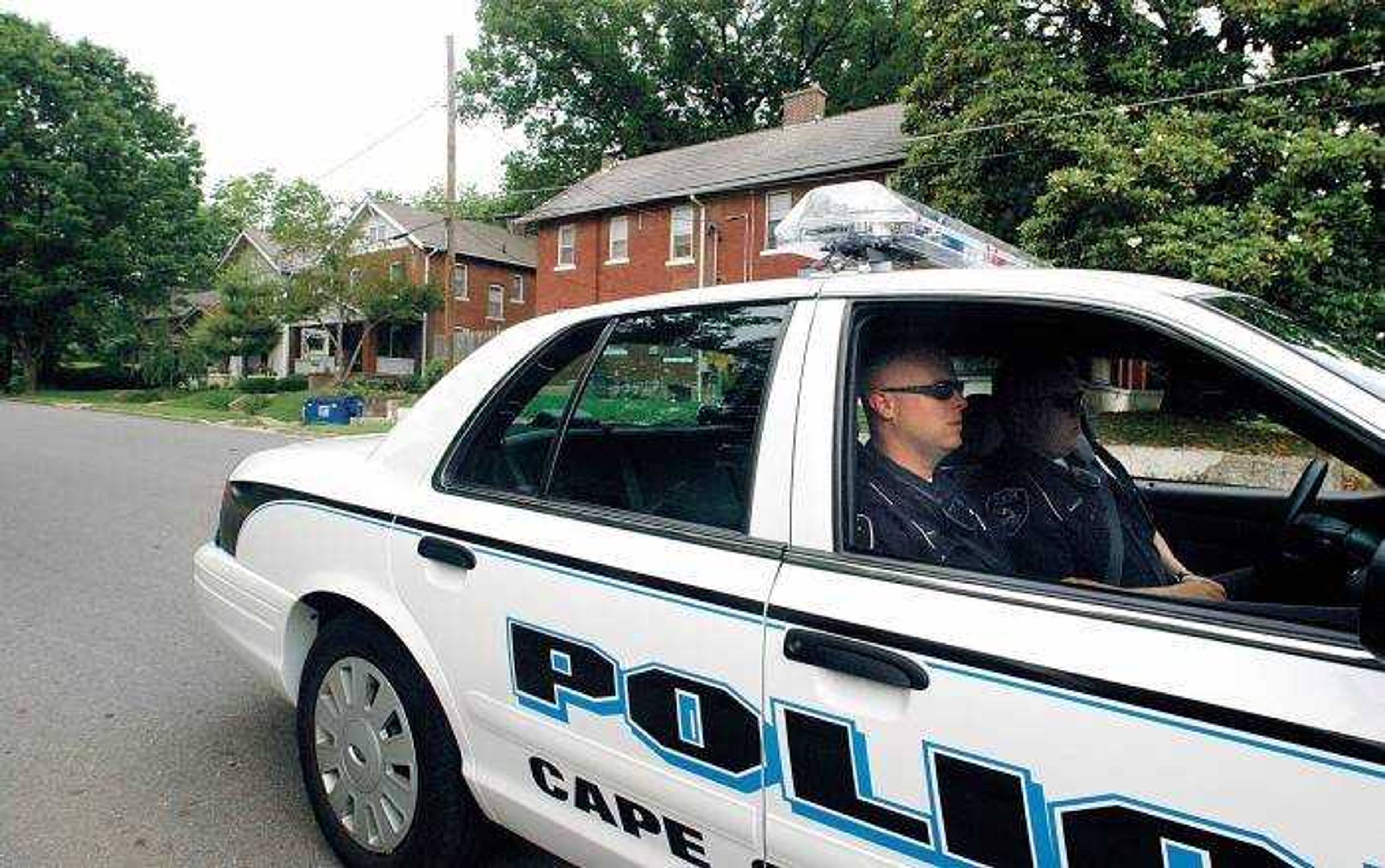 Officers Aaron Brown, left, and Jason Jurgens sat at the corner of Merriwether and Lorimier streets, an area patrolled as a part of the Cape Girardeau Police Department's new tactical shift, on Thursday. The program, started in May, allots officers to simply patrol the streets. (Aaron Eisenhauer)