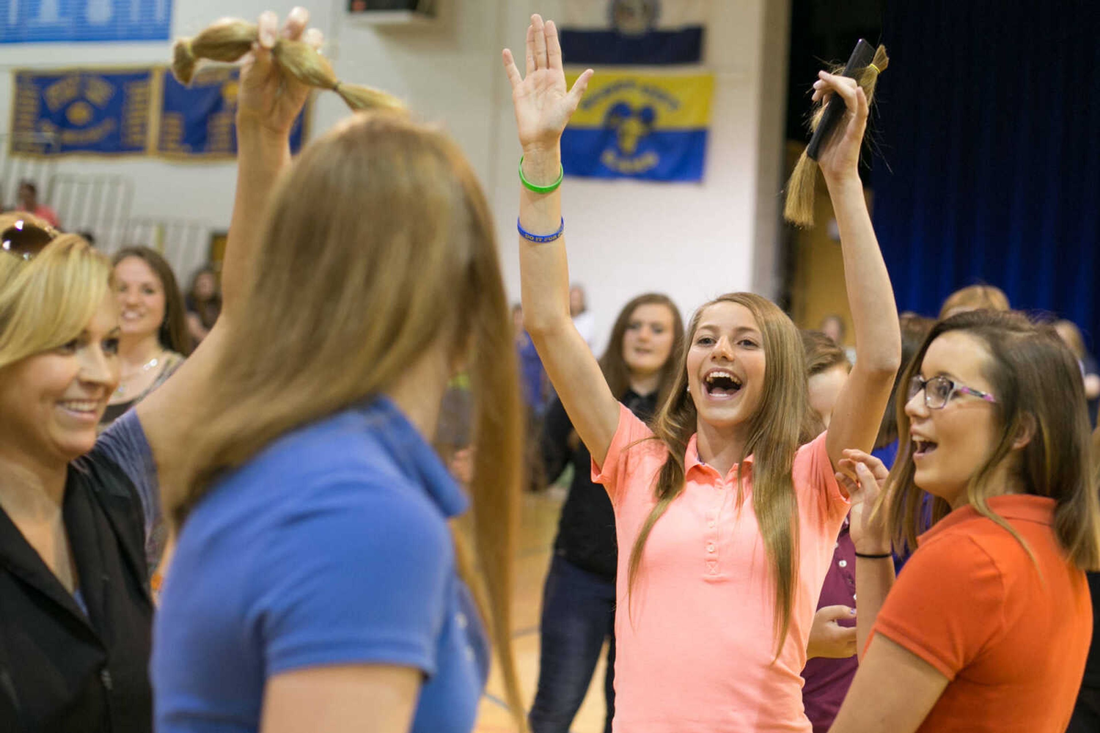 GLENN LANDBERG ~ glandberg@semissourian.com

Paige Cummins celebrates after Kaileigh Dirden has her hair cut and donated to the Beautiful Lengths program Monday, May 18, 2015 at Scott City High School. Twenty-four students and teachers participated in the event that provides wigs to cancer patients across the country.