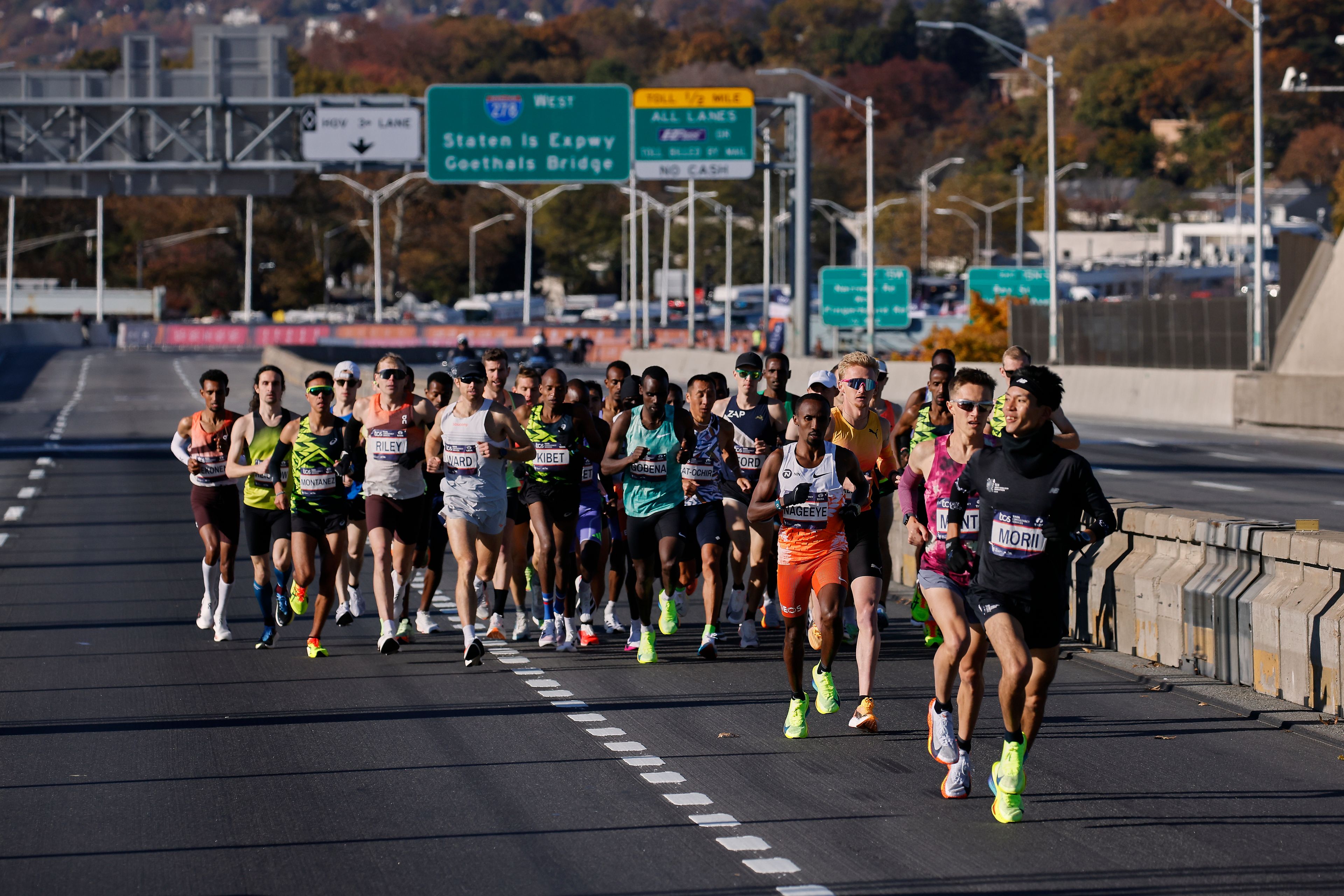 Yuma Morii, right, of Japan, makes his way onto the Verrazzano Narrows bridge with runners in the men's elite division make their way from the start line during the New York City Marathon, Sunday, Nov. 3, 2024, in New York. (AP Photo/Eduardo Munoz Alvarez)