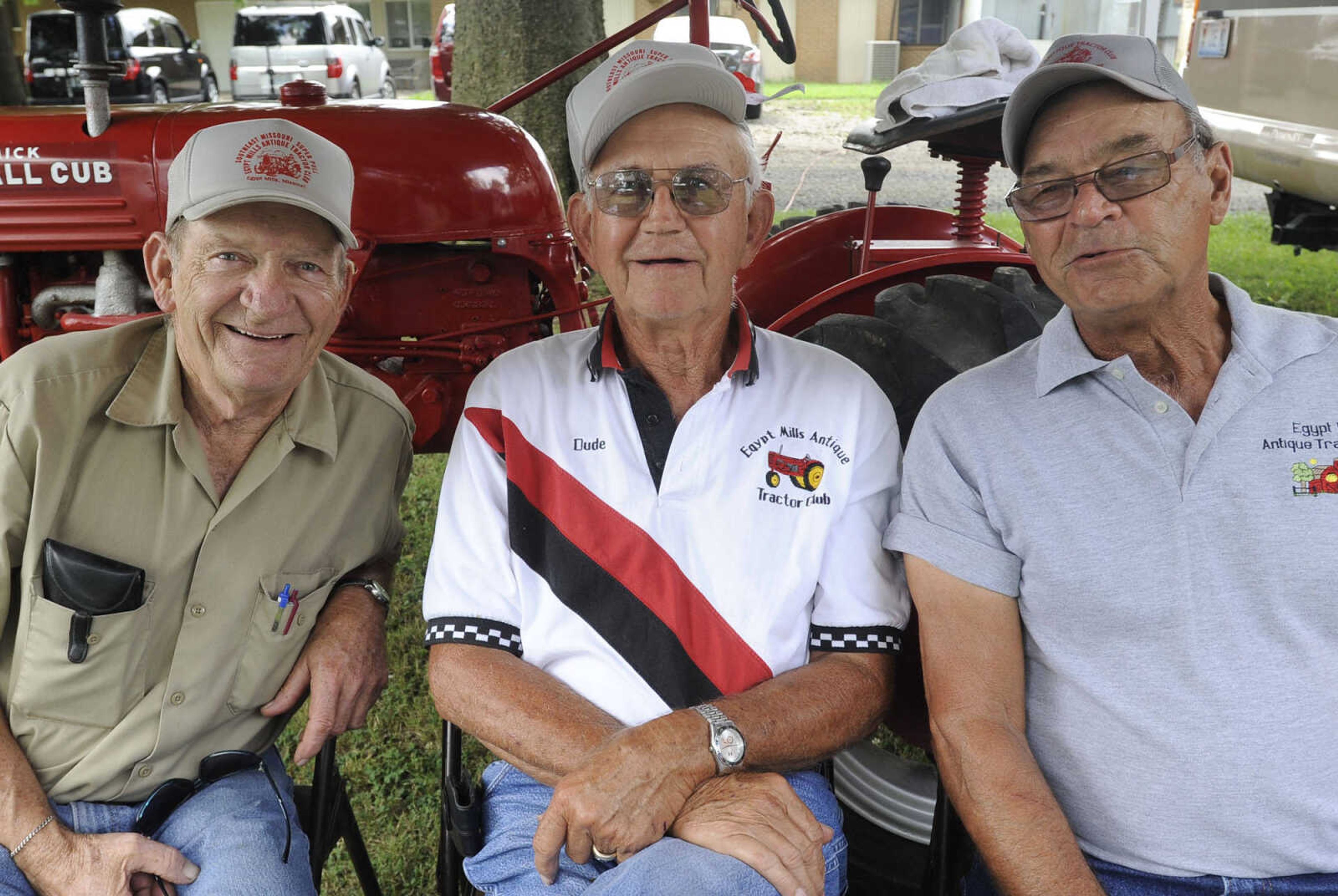 Bob Haggett, left, Dude Huey and Jim Foeste with the Egypt Mills Antique Tractor Club pose for a photo at German Days on Saturday, Aug. 9, 2014 at Frisco Park in Chaffee, Missouri.