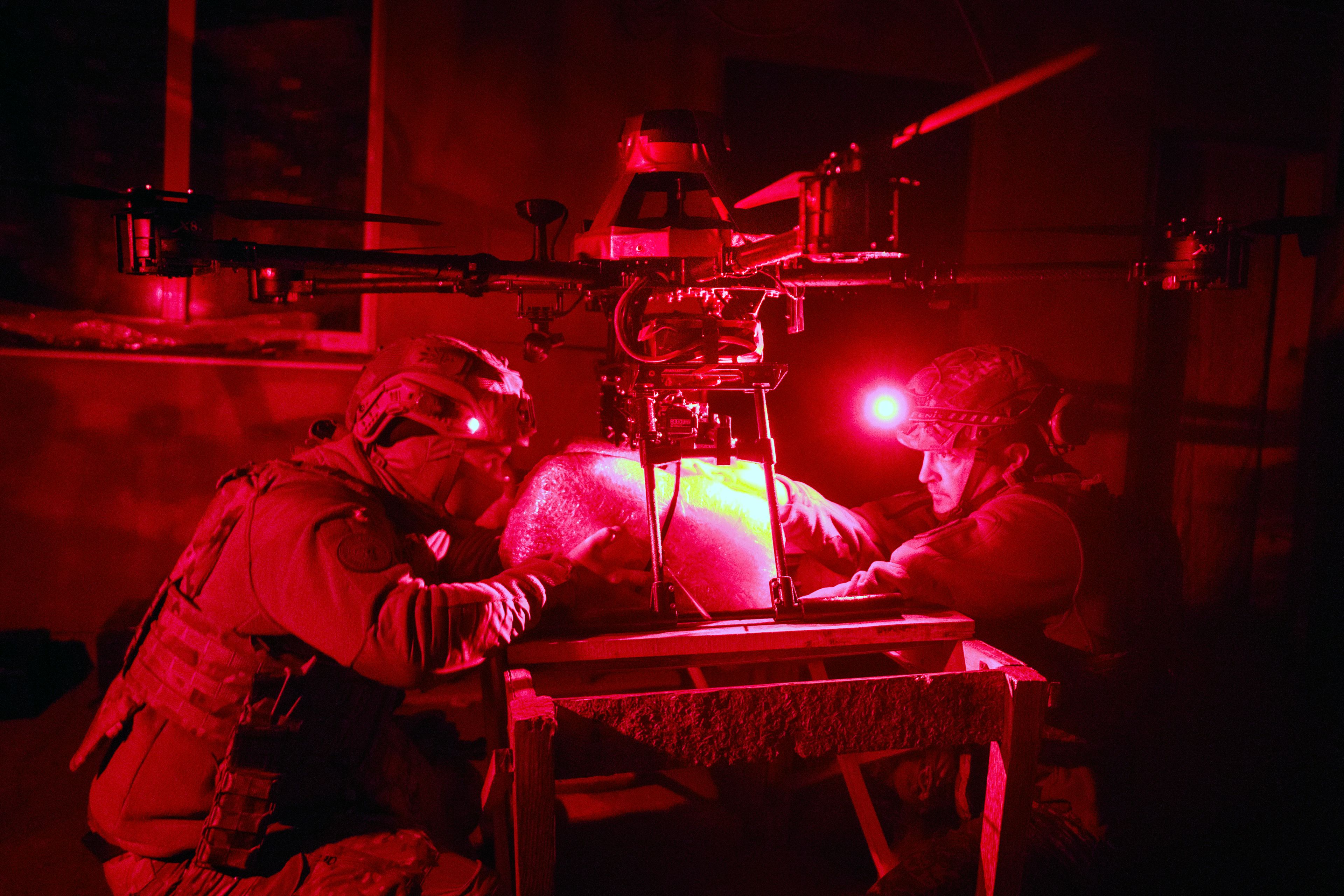 Servicemen of Ukraine's Khartia brigade pack a Vampire drone with food and water to launch toward the frontline to Ukrainian positions near Kharkiv, Ukraine, late Thursday, Nov. 7, 2024. (AP Photo/Efrem Lukatsky)