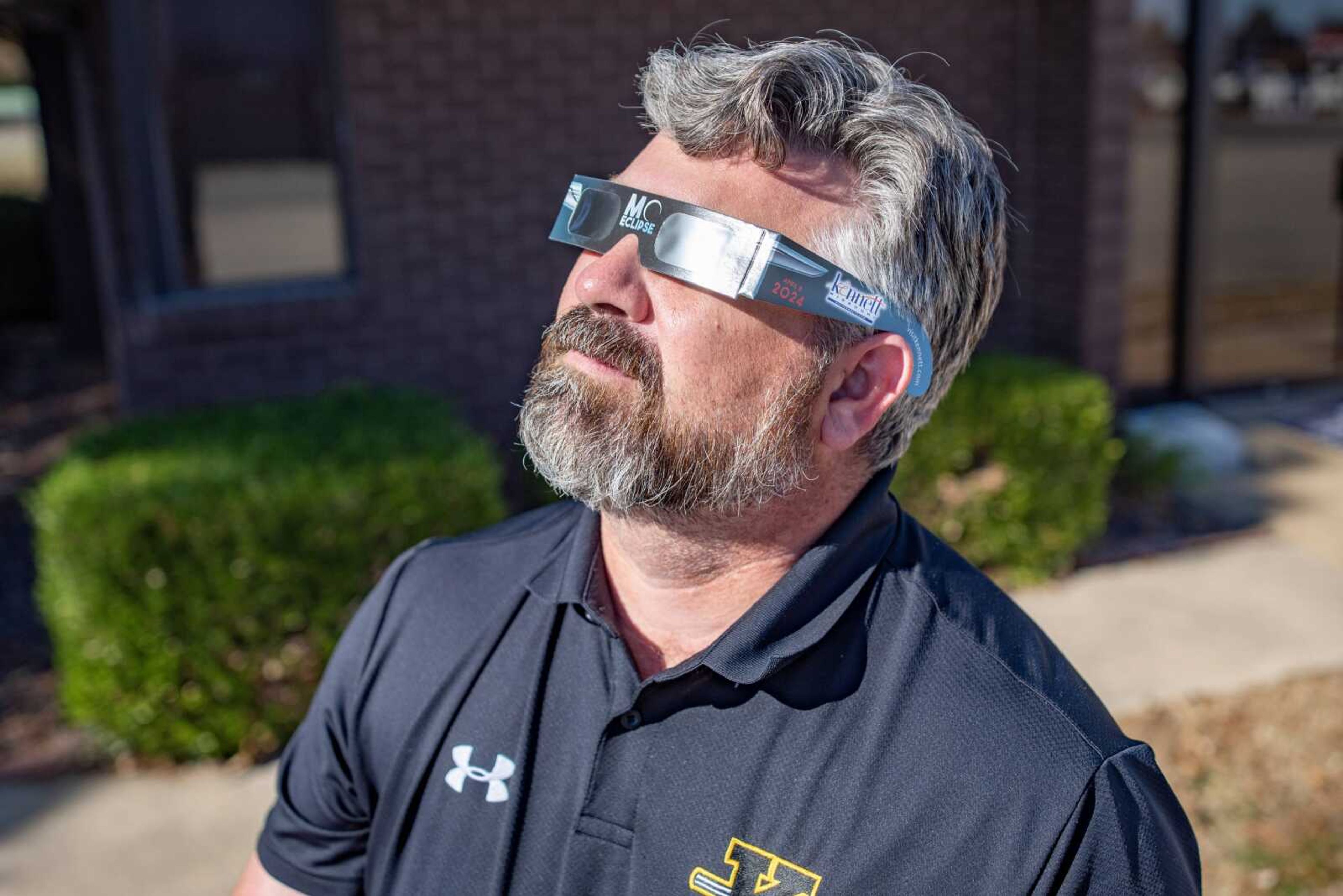 Kennett Chamber of Commerce executive director Danny Ray models a pair of customized Kennett eclipse glasses.