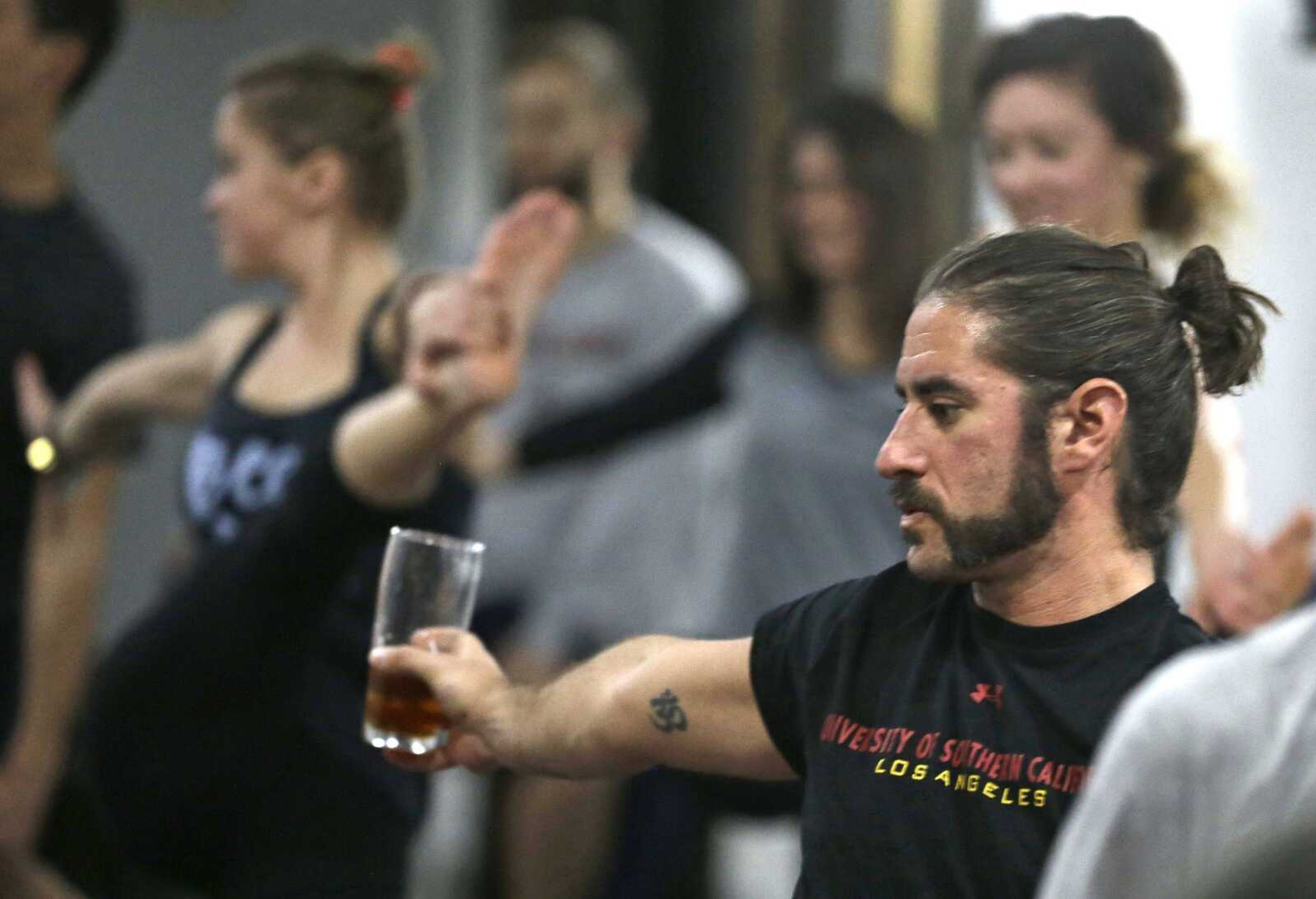 Reed Patterson practices yoga while holding onto his beer Dec. 3 at the Platform Beer Co. in Cleveland. (AP Photo/Tony Dejak)