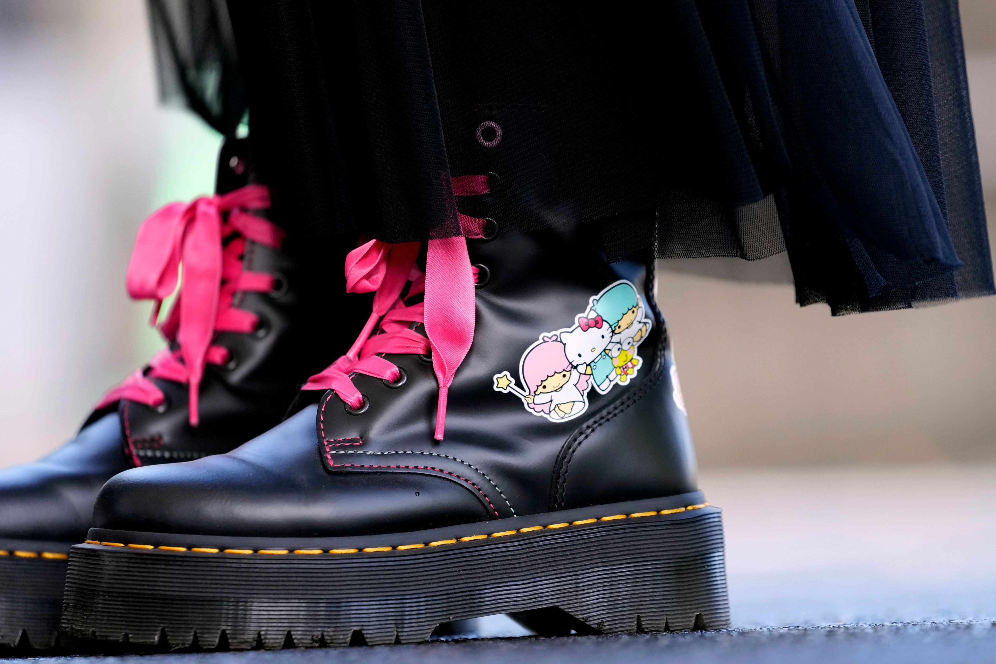 A visitor wears boots featuring Hello Kitty at the National Museum during the exhibition "As I change, so does she," marking the 50th anniversary of Hello Kitty at the Tokyo National Museum in Tokyo Wednesday, Oct. 30, 2024. (AP Photo/Shuji Kajiyama)