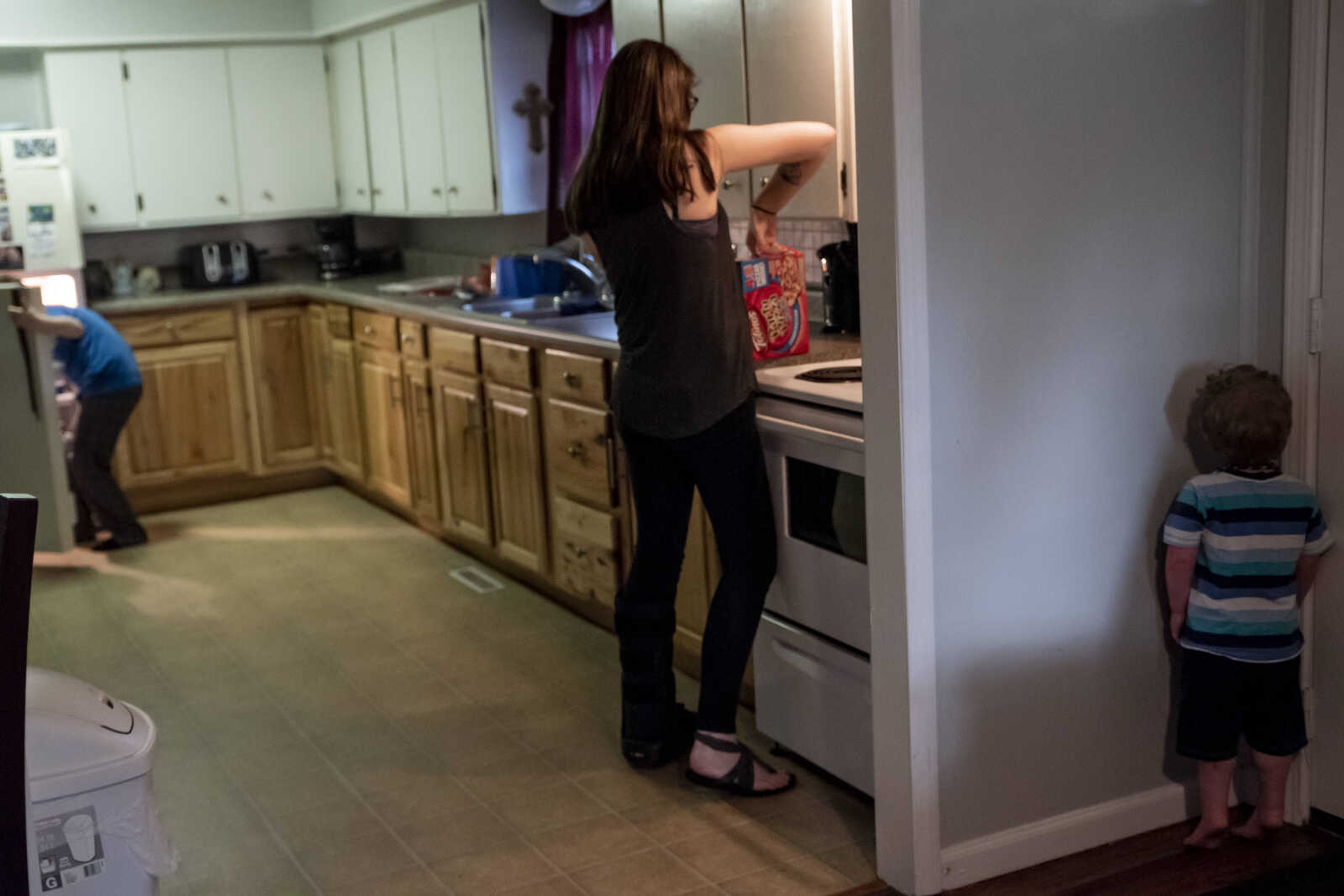 Emily Medlock, center, prepares a pizza while her son Phoenix Young, 2, stands in time out at home Tuesday, May 7, 2019, in Cape Girardeau.