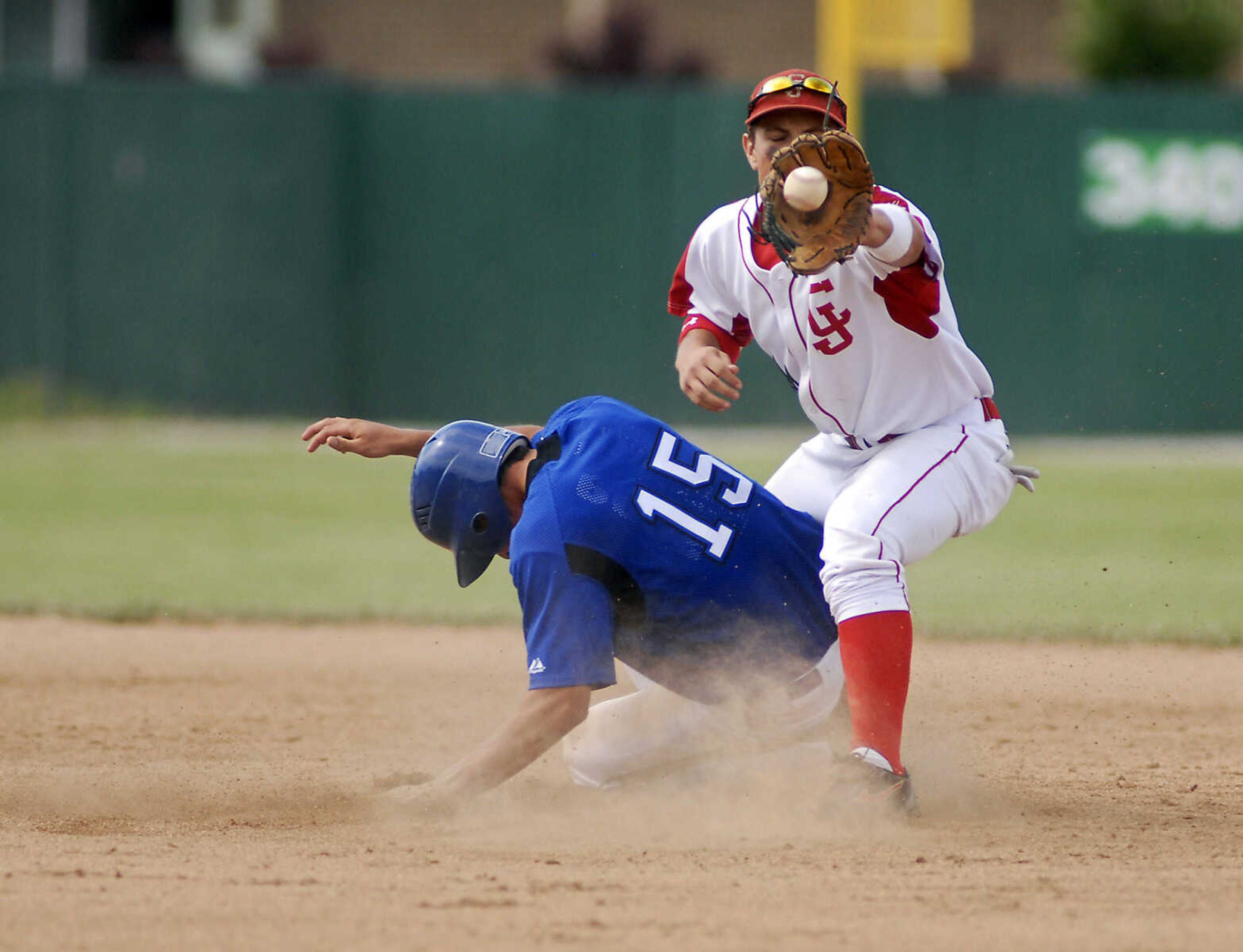 JUSTIN KELLEY photo
Notre Dame's Mark Glastetter slides safely into second base as Carl Junction's Jack Luton catches the ball during the Class 3 championship game Saturday, June, 6 2009, at Meador Park in Springfield.