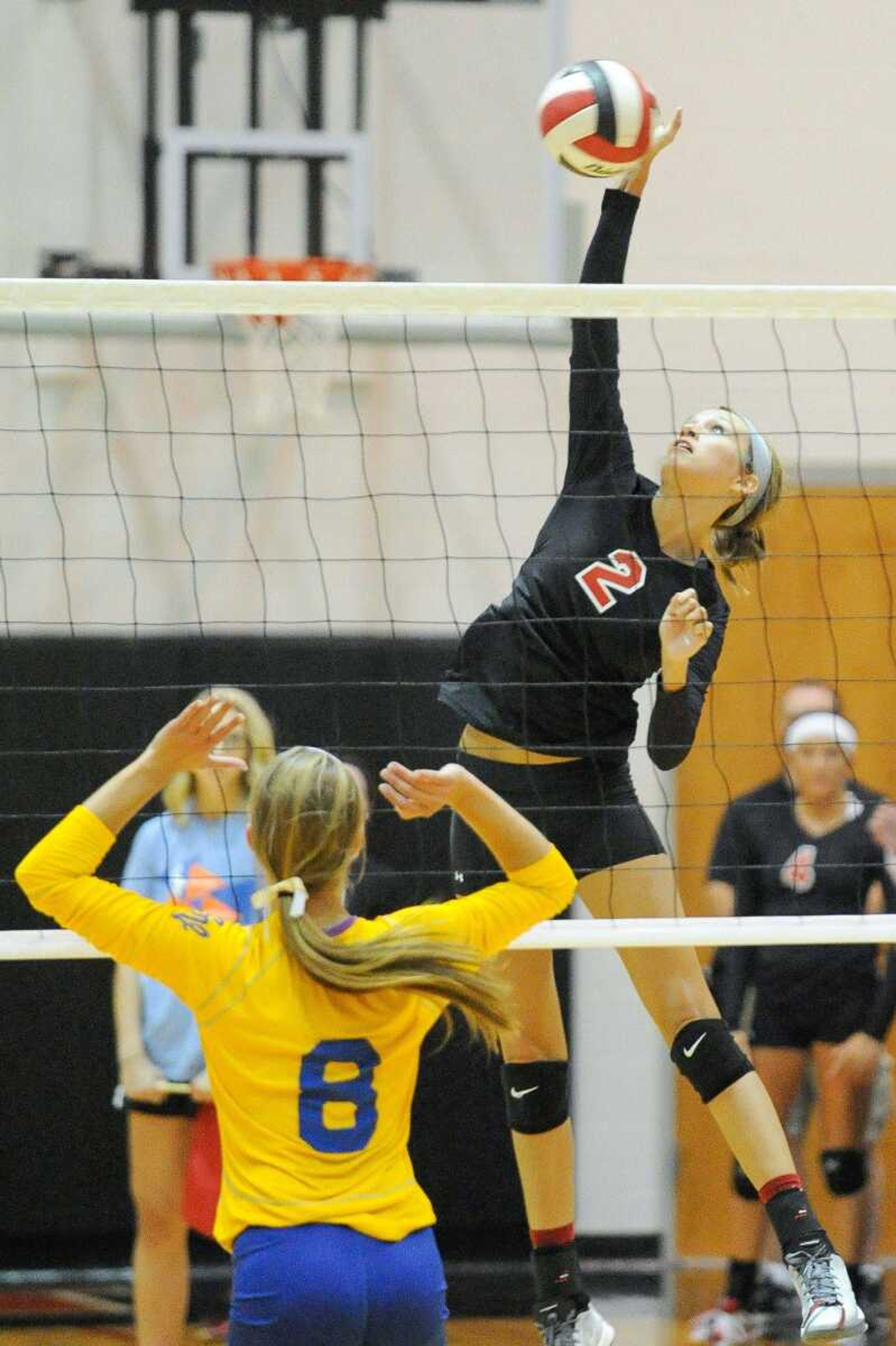 Jackson's Autumn Reid spikes the ball against St. Vincent's Karly Huber during the second set Tuesday, Aug. 25, 2015 in Jackson. (Glenn Landberg)