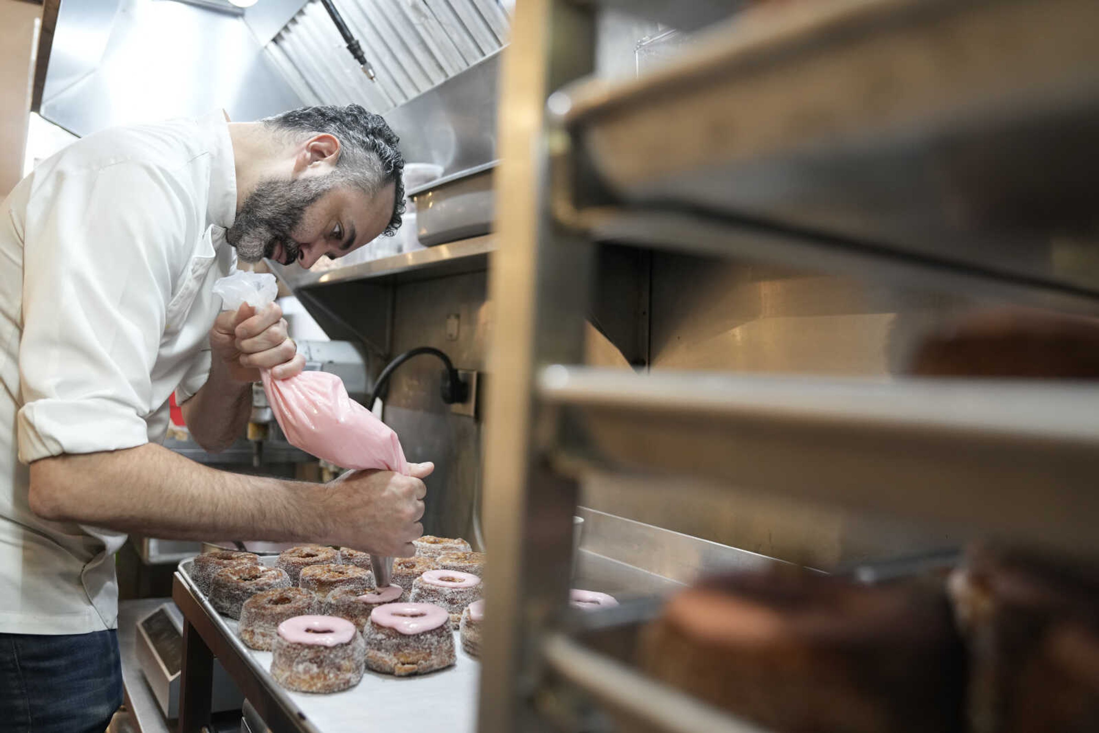 Dominique Ansel ices Cronuts before the opening of his namesake bakery Sept. 28 in New York.