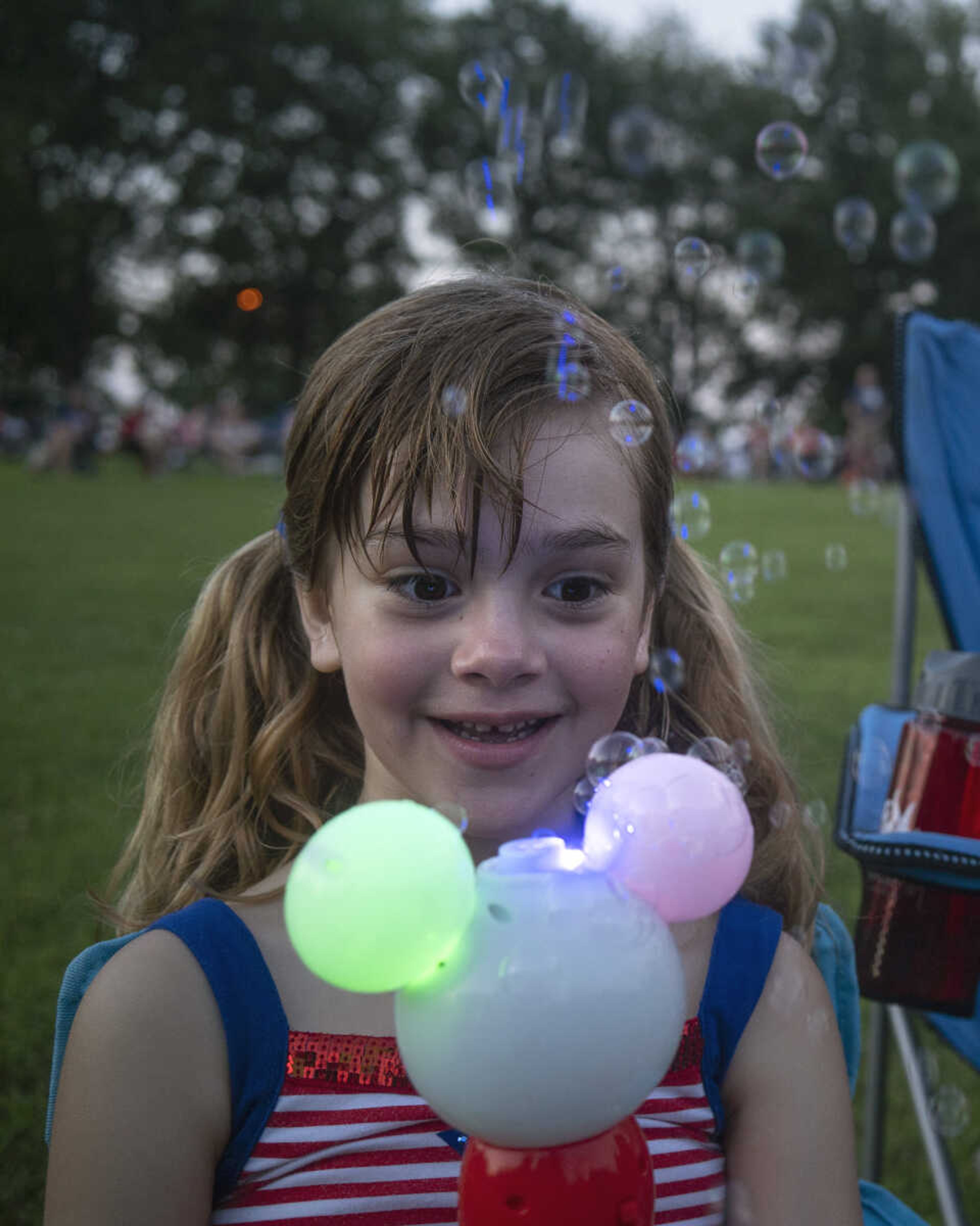 Mirren Martinez, 5, plays with a bubble machine during an Independence Day celebration at the Jackson Municipal Band Shell.