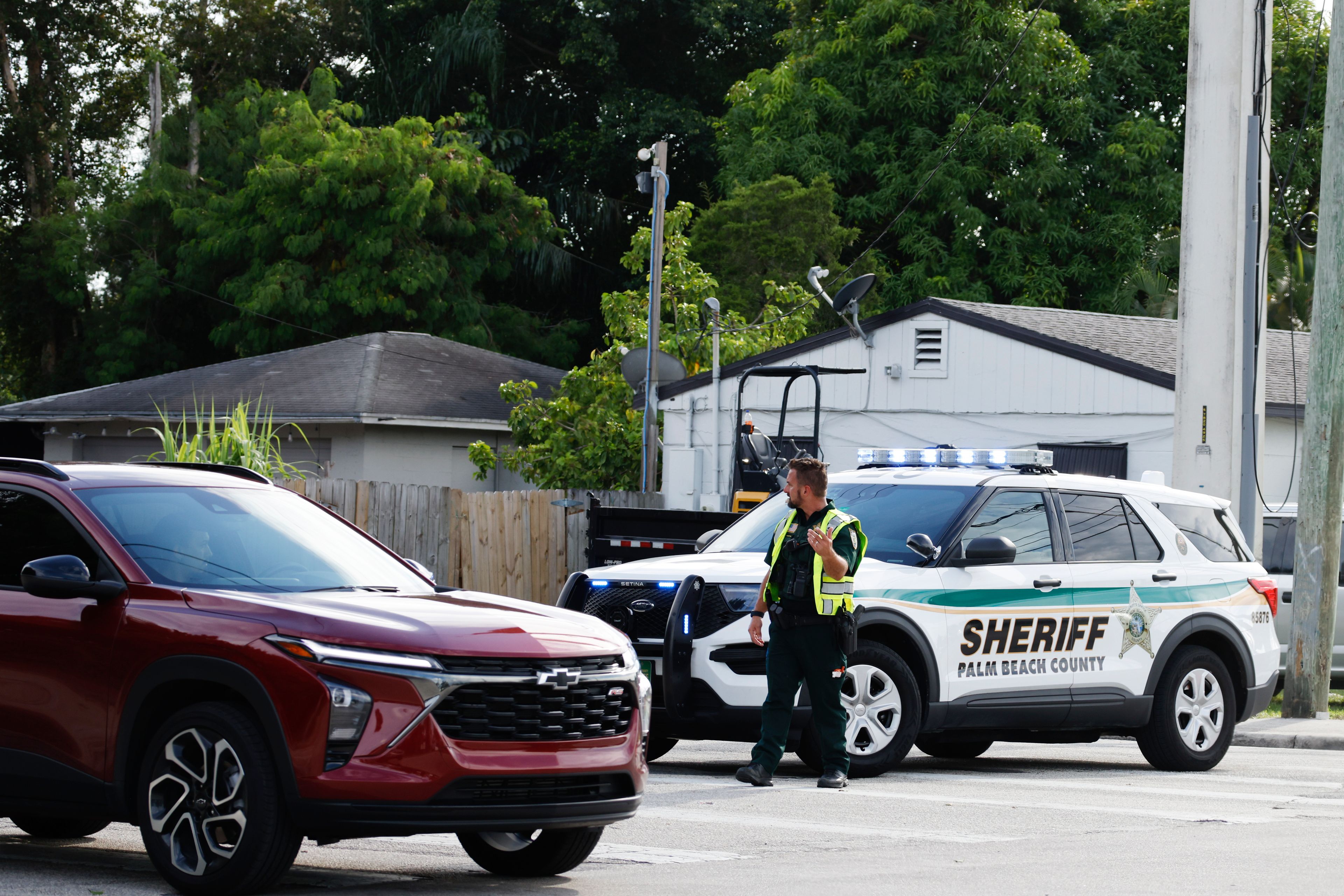 A police officer directs traffic near Trump International Golf Club after the apparent assassination attempt of Republican presidential nominee former President Donald Trump in West Palm Beach, Fla., Sunday, Sept. 15, 2024. (AP Photo/Terry Renna)