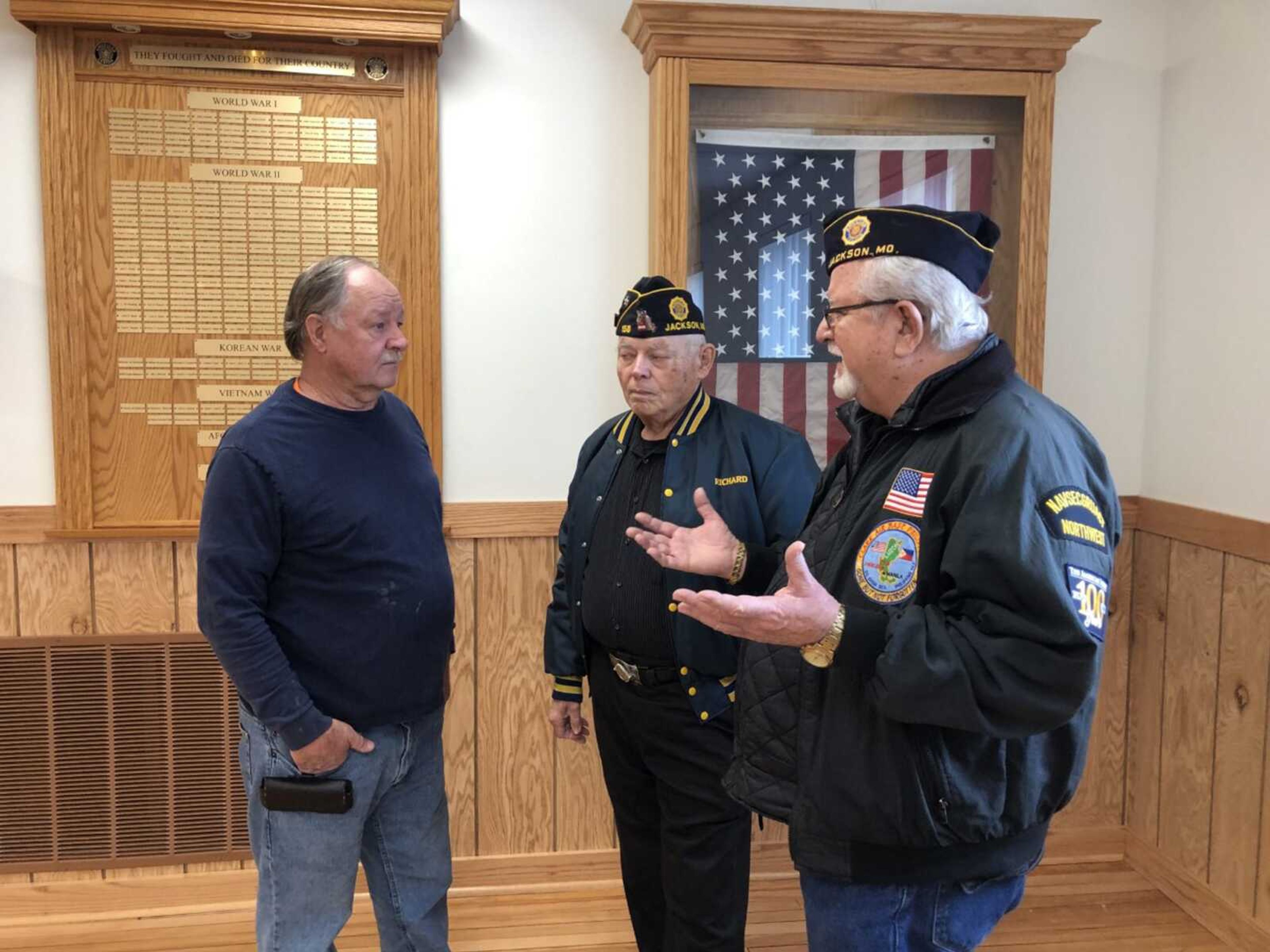 David Ludwig, right, a past commander of American Legion Post 158 in Jackson, talks with Columbia Construction superintendent Gary Rees, left, and American Legion head trustee Richard Welker following reopening ceremonies of the post building Tuesday. The structure was heavily damaged by a storm June 21.