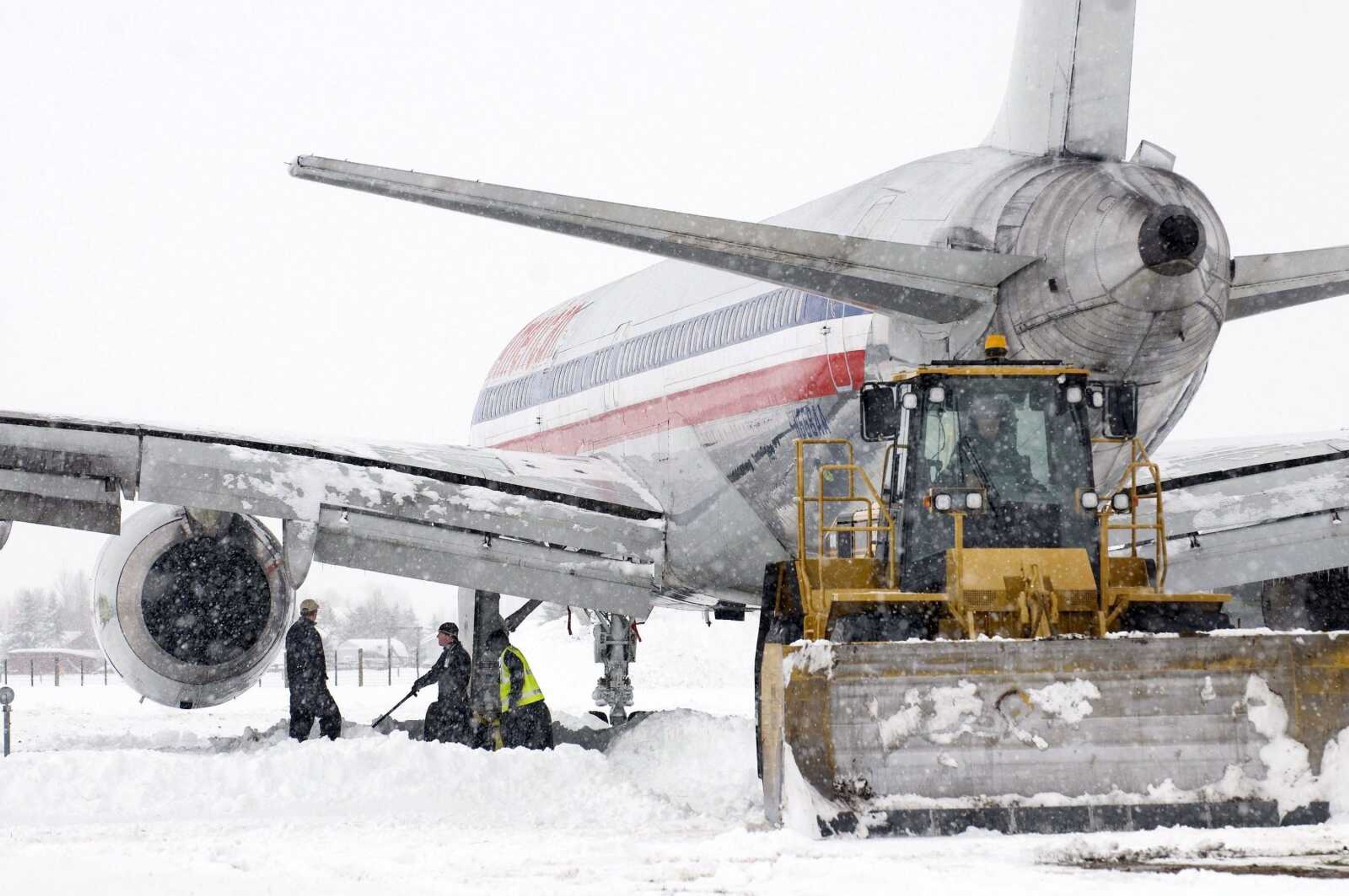 Crews dig out an American Airlines 757 airplane that slid more than 650 feet off the end of the runway Wednesday at Jackson Hole Airport near Jackson, Wyo. (Bradly J. Boner ~ Jackson Hole News &amp; Guide)