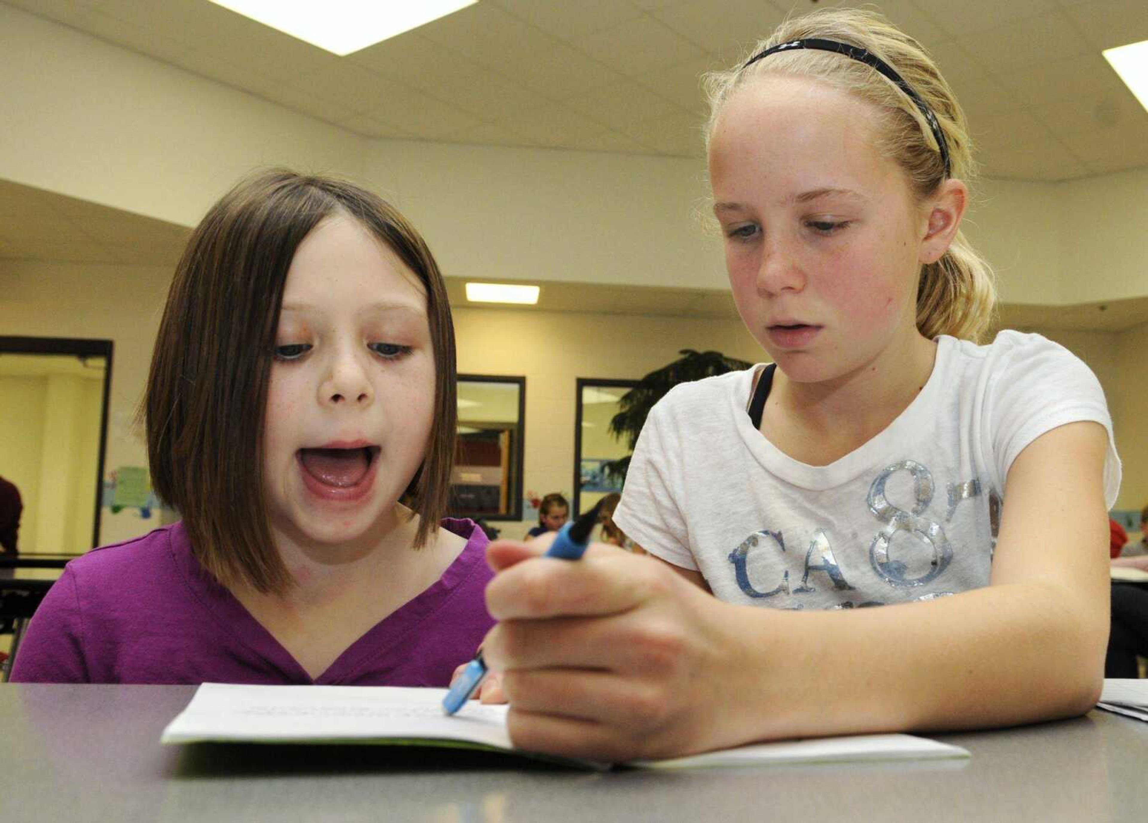 Fifth-grader Ana Compton, 11, right, helps first-grader Mia Bilderbeck, 6, read a story Friday during a reading intervention program at South Elementary School in Jackson. The program started this year with the use of federal stimulus money. (KRISTIN EBERTS)