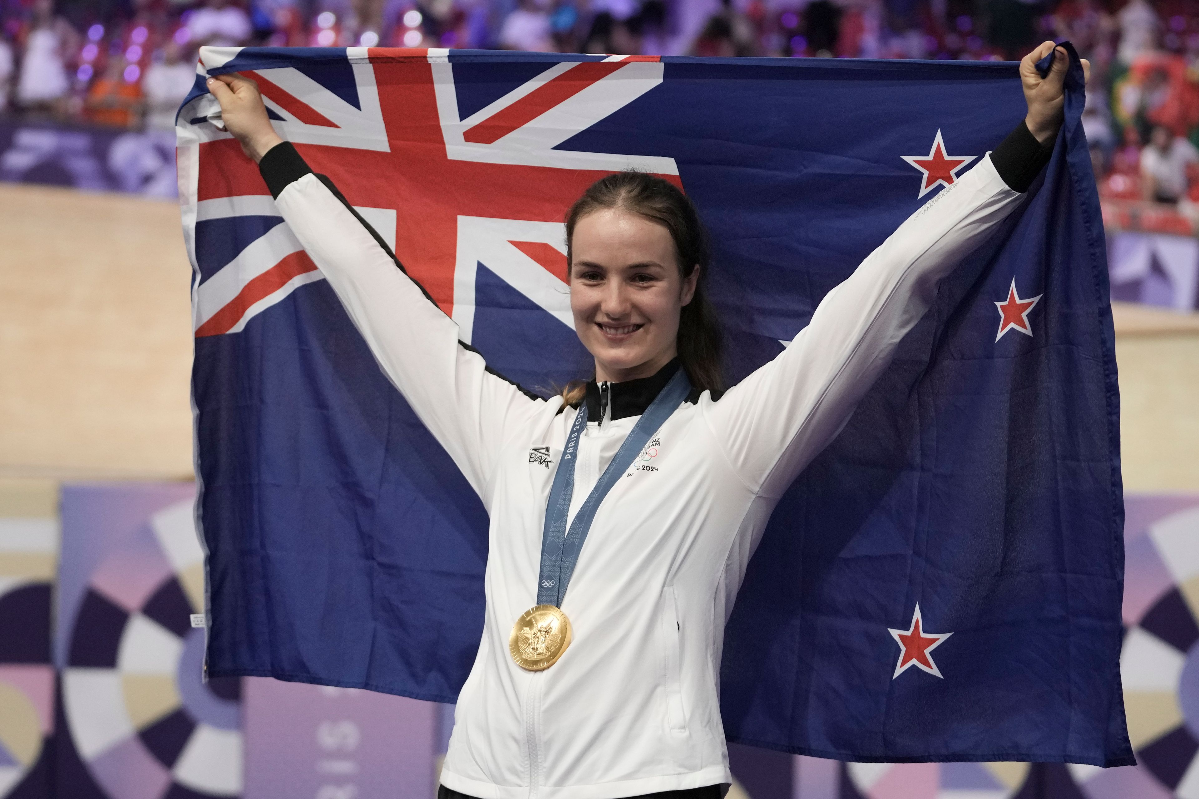 Ellesse Andrews of New Zealand poses with the gold medal of the women's sprint event, at the Summer Olympics, Sunday, Aug. 11, 2024, in Paris, France. (AP Photo/Thibault Camus)