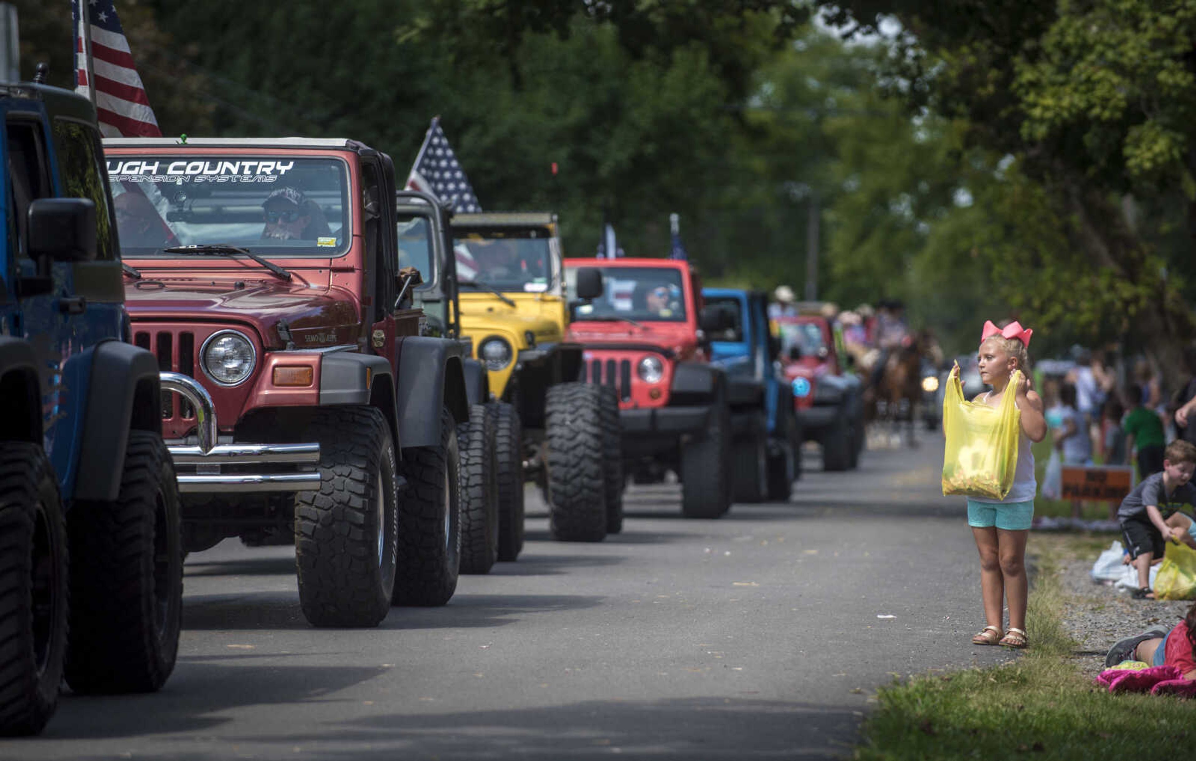 A girl waits for candy to be thrown to her from the parade route during Benton Neighbor Days Saturday, September 1, 2018.