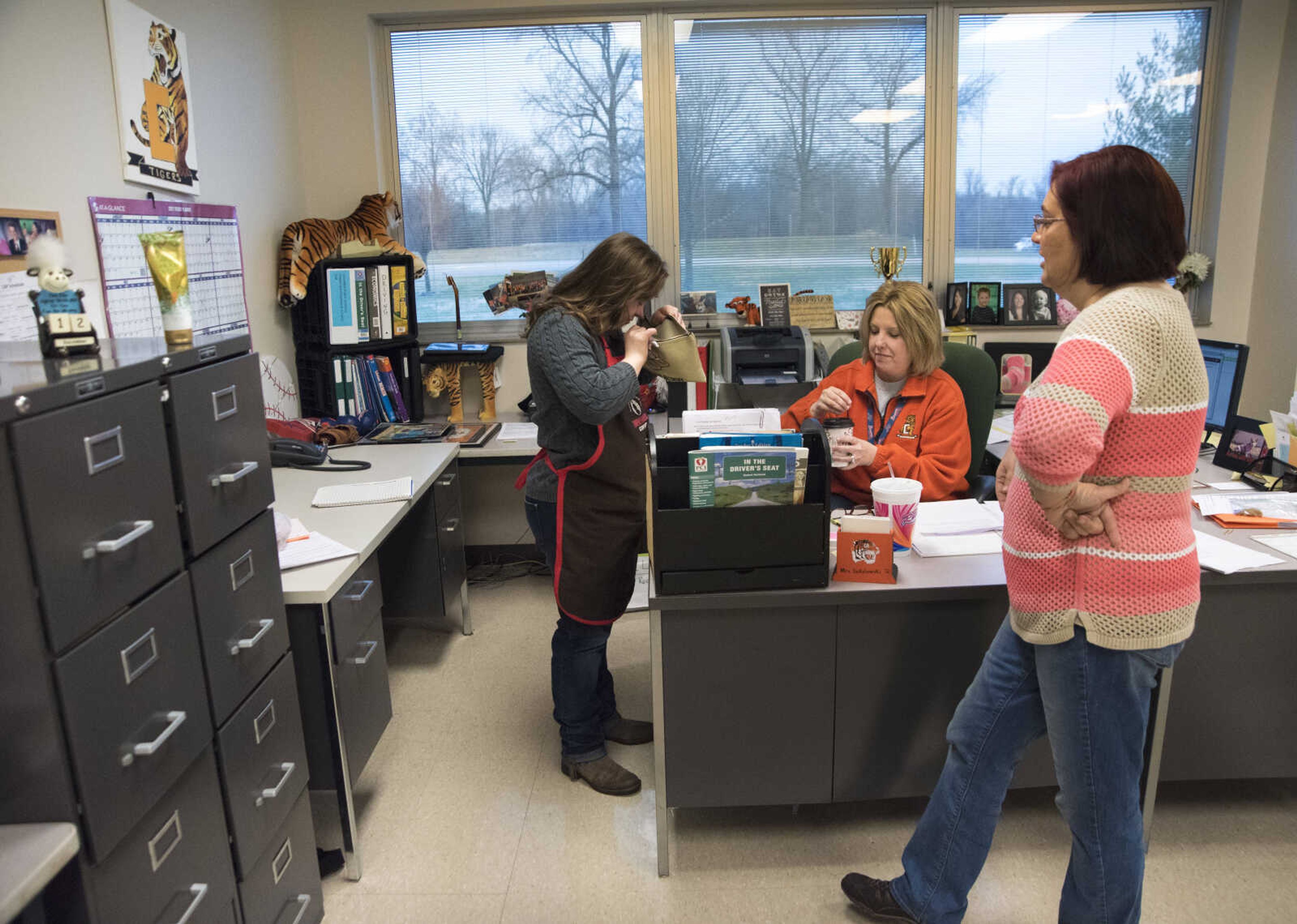 ANDREW J. WHITAKER ~ awhitaker@semissourian.com
Carley House, left, looks for change to give to Errikka Sokolowski, center, for Tiger Brew, a student run business run by the special education department at Cape Girardeau Central, Tuesday, Dec. 13, 2016 in Cape Girardeau. Tiger Brew is available Monday through Friday during three different class periods, 1st hour, 2nd hour and advisory and offer a variety of drinks from hot coffees and teas, iced drinks, hot chocolates and even smoothies.