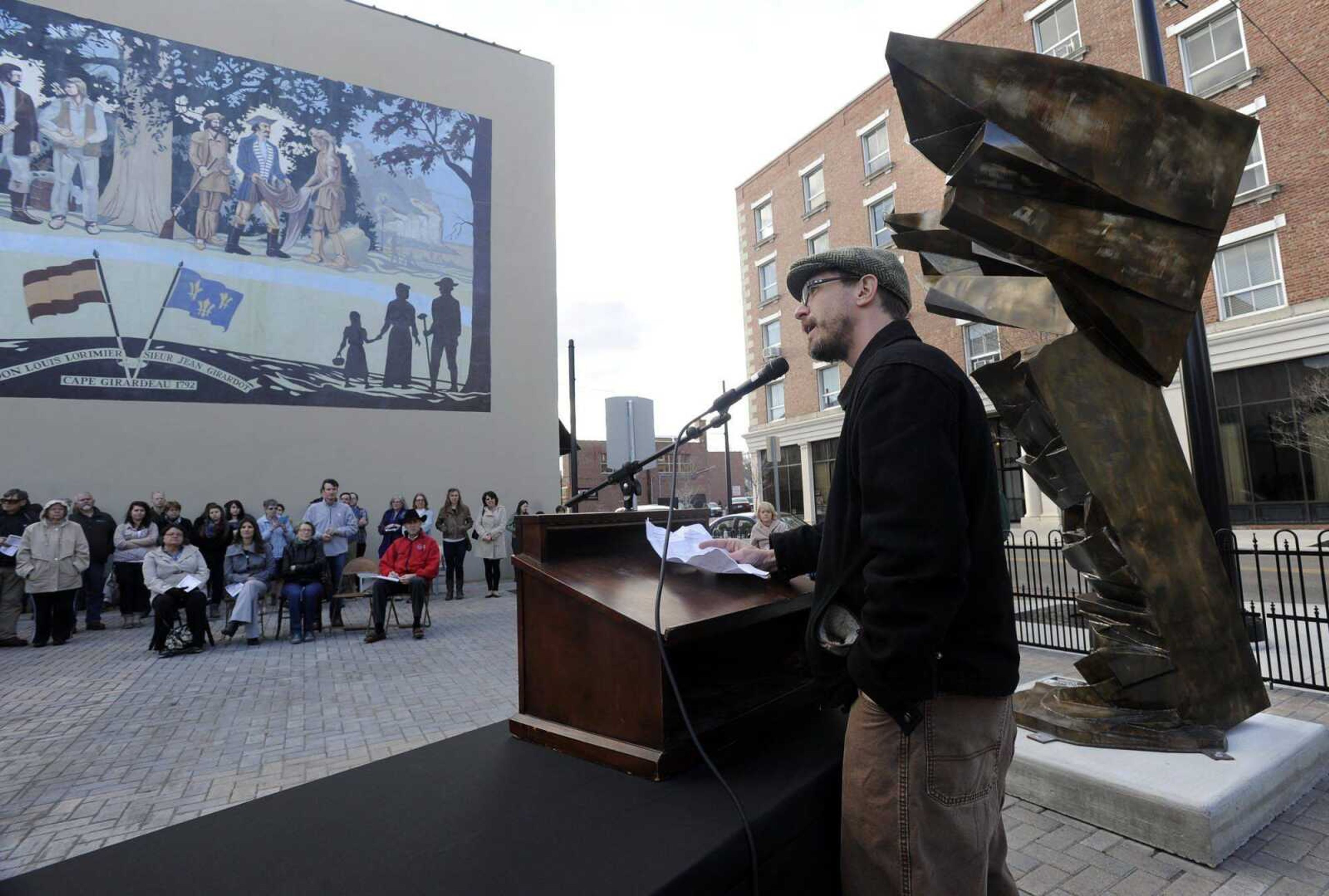 Chris Wubbena speaks next to his sculpture, &#8220;Victoria,&#8221; at the opening reception for the Cape Girardeau Outdoor Sculpture Exhibition on Friday at the Vasterling Suites Courtyard. More pictures of the reception and the sculptures are in a gallery at semissourian.com. (Fred Lynch)