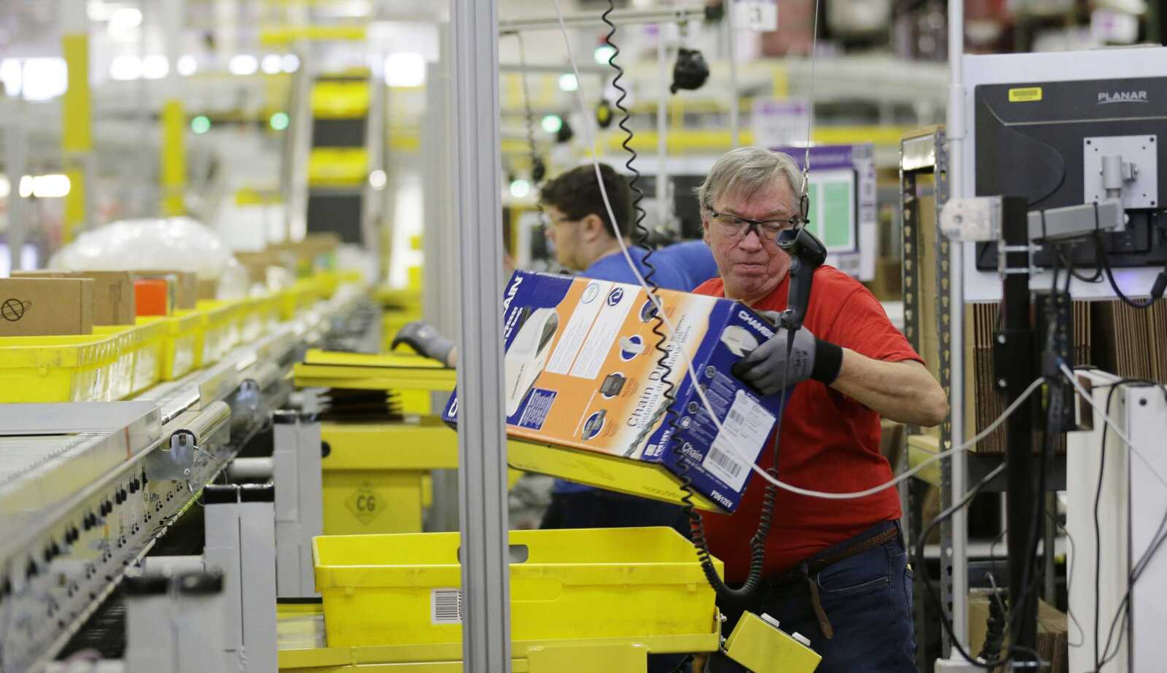 A worker processes outgoing orders at Amazon.com's fulfillment center in DuPont, Washington. Last week, Amazon said it's looking to fill more than 50,000 positions across its U.S. fulfillment network.