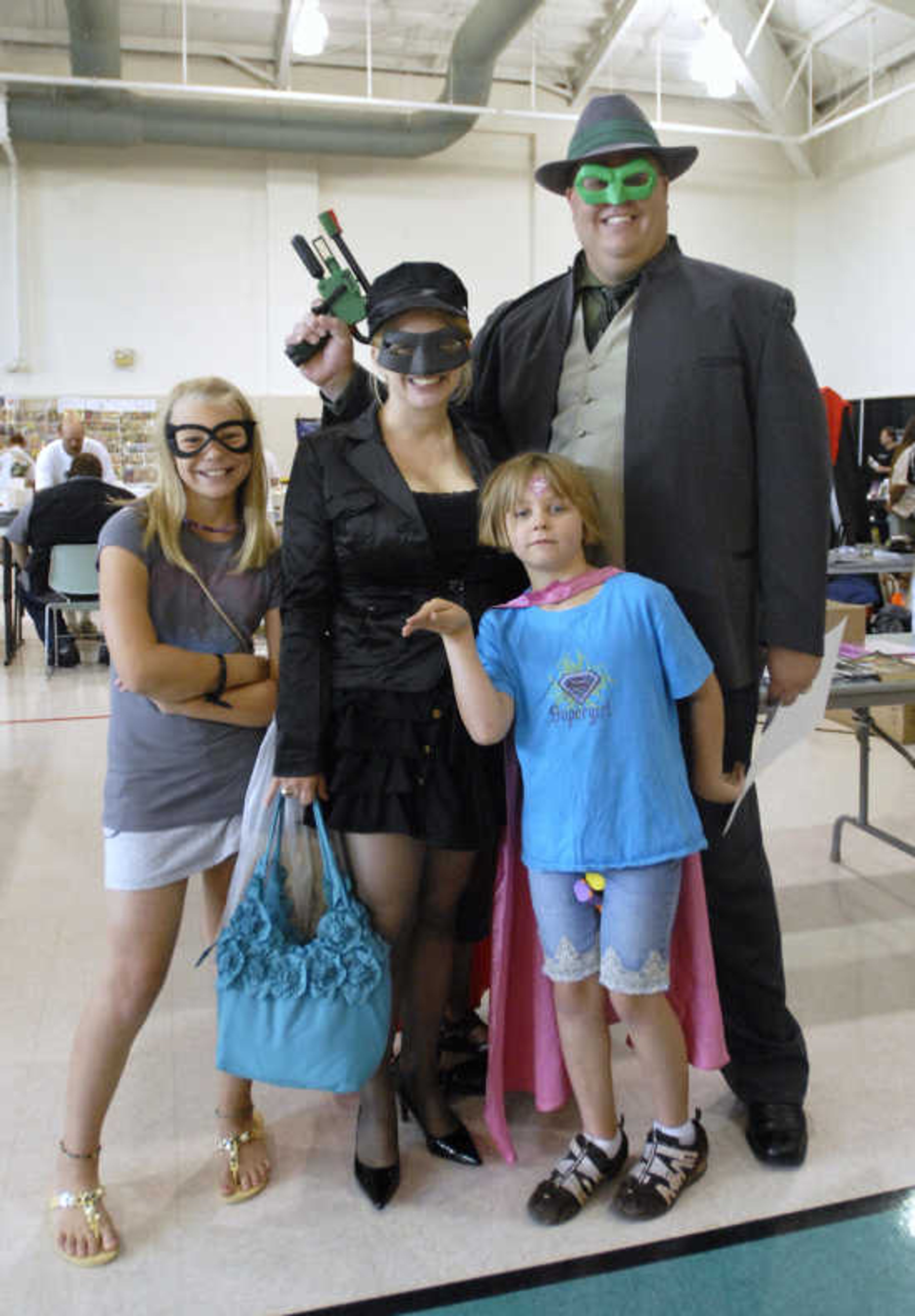 From left, Lexi Spurgeon, 10, as Batgirl, Laura Spurgeon, as Kato, Anya Spurgeon, 7, as Supergirl, and Jay Spurgeon, as The Green Hornet, pose during the sixth annual Cape Comic Con on Saturday, June 25, 2011, at the Osage Centre in Cape Girardeau.