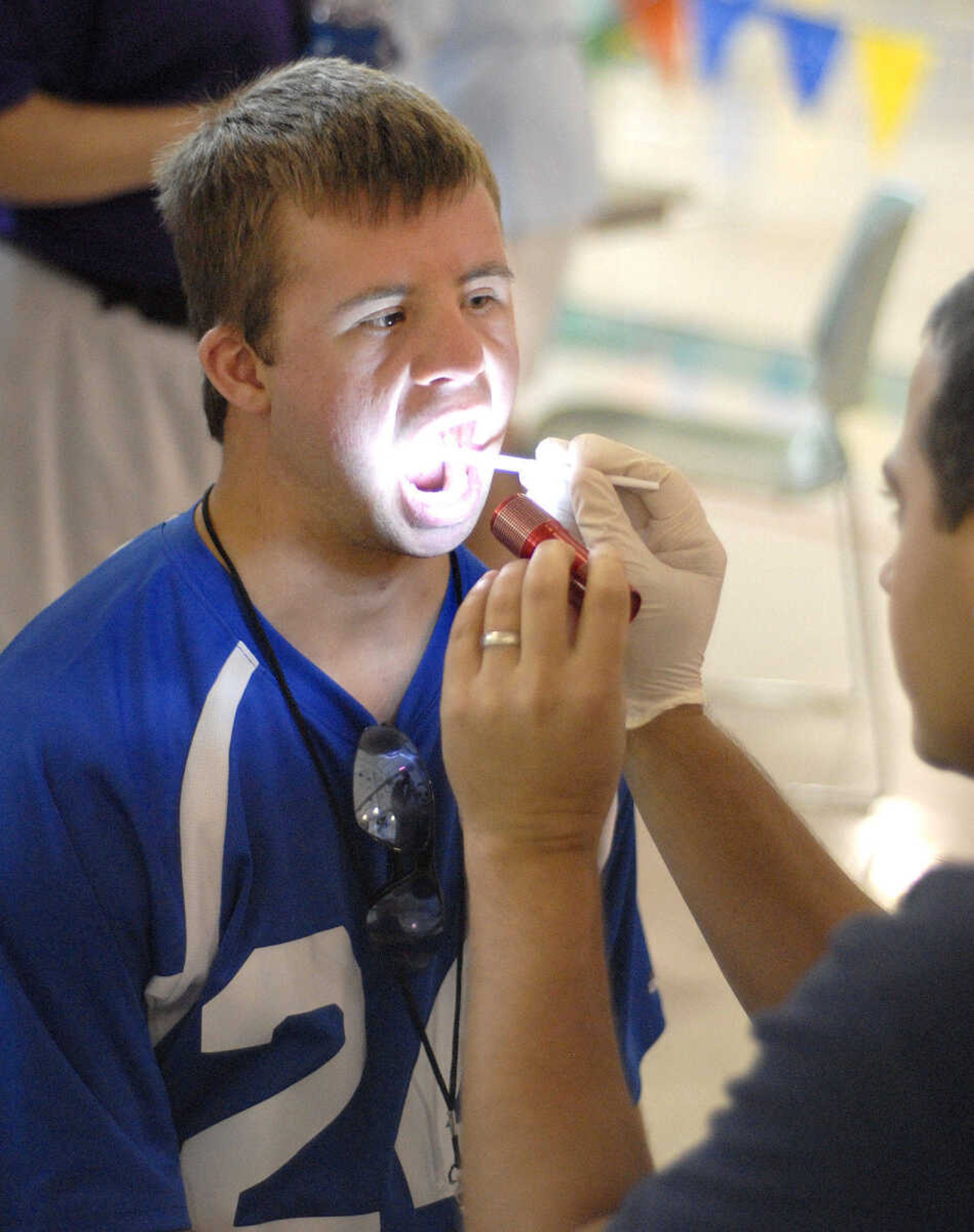 LAURA SIMON ~ lsimon@semissourian.com
Dr. Jim Fox gives a dental exam to Nicholas McMullen at Victory Village inside the the Osage Centre Saturday, August 13, 2011 in Cape Girardeau.