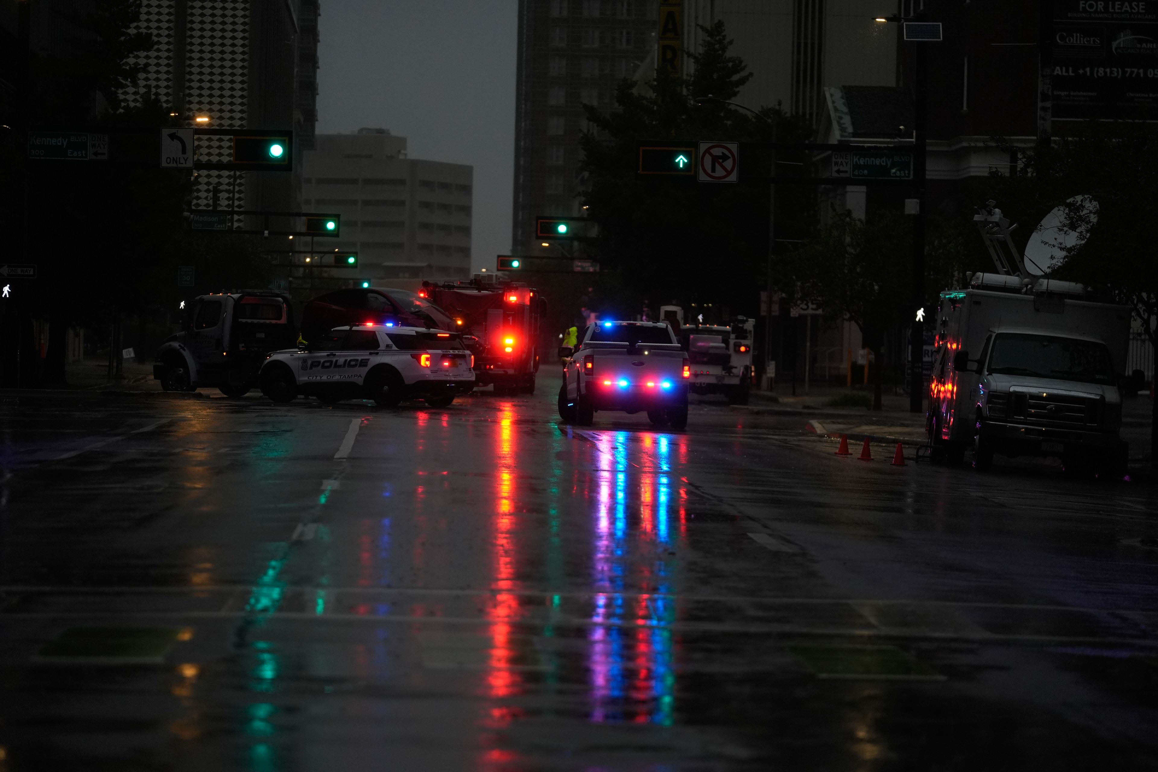 Police respond to a traffic accident between a car and a fire truck returning from a call, on near-deserted streets in downtown Tampa, Fla., during the approach of Hurricane Milton, Wednesday, Oct. 9, 2024. (AP Photo/Rebecca Blackwell)