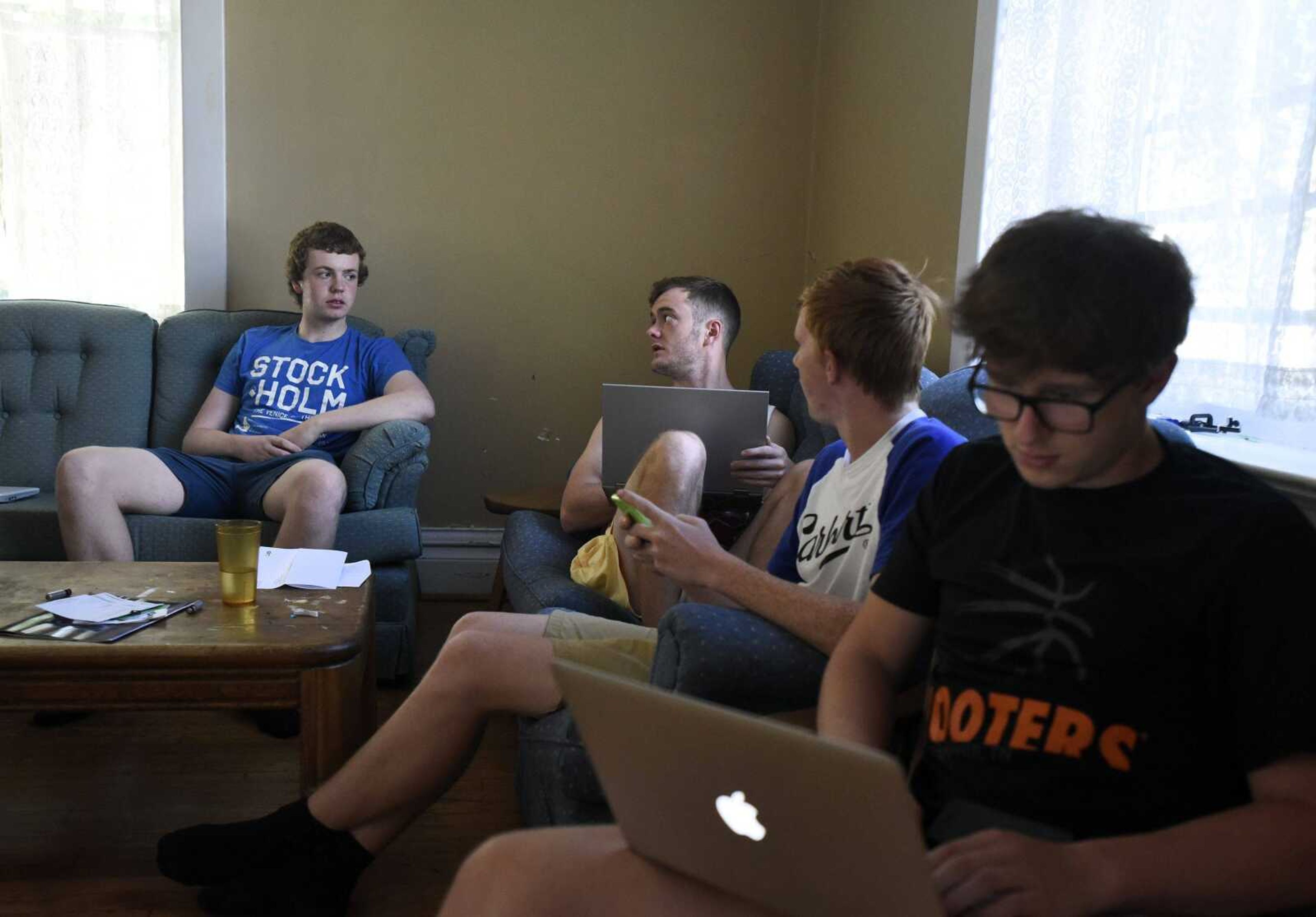 From left to right, Conal O Brien and Scott Sullivan from Ireland, Bjarke Schack from Denmark, and Sam Compton from England, hang out inside their home in Cape Girardeau on Monday, Sept. 26, 2016.