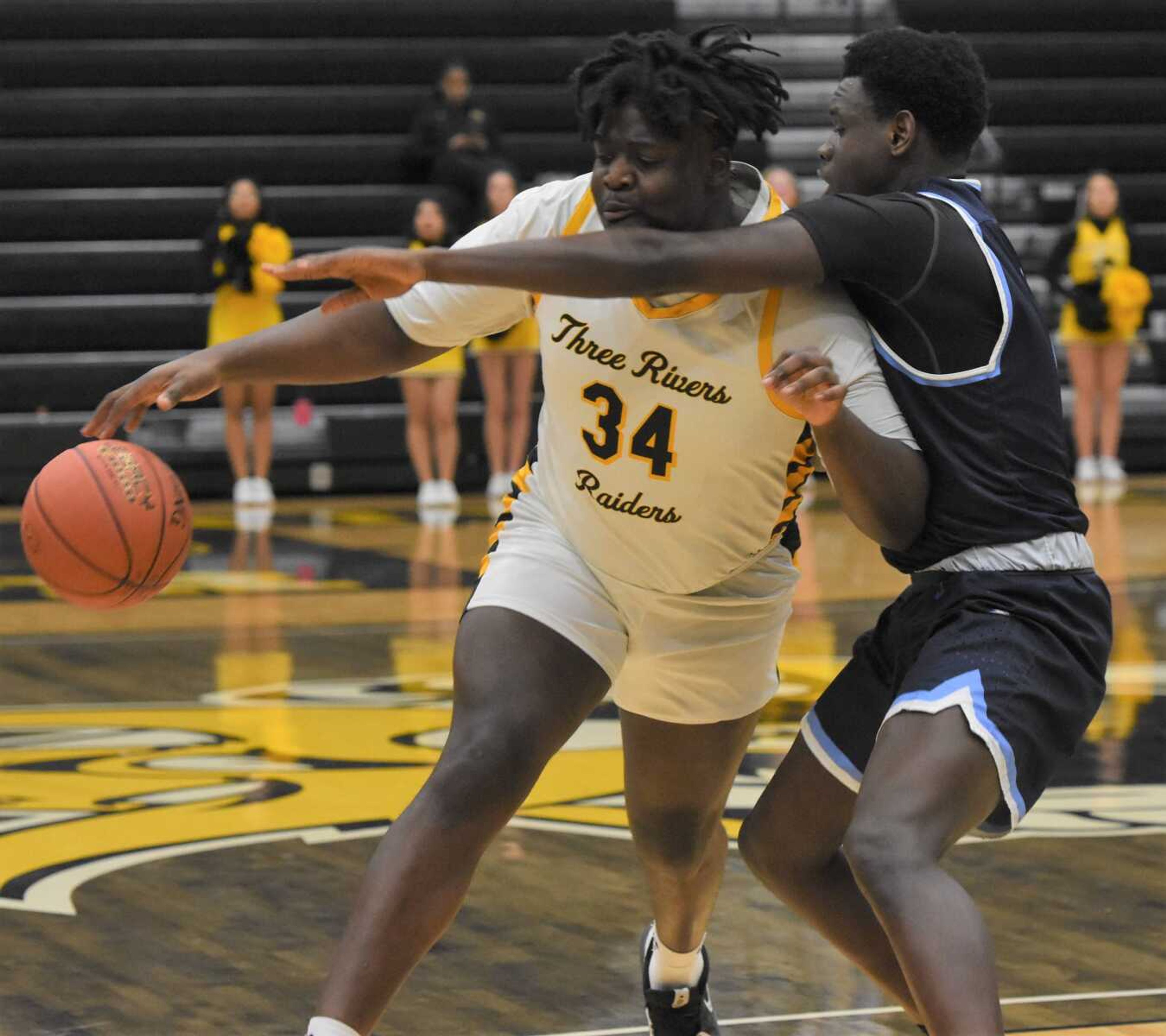 You can't do that. Three Rivers' Hosane Kitenge, left, gets clobbered on the way to the hoop during the Raiders win over visiting State Fair CC.