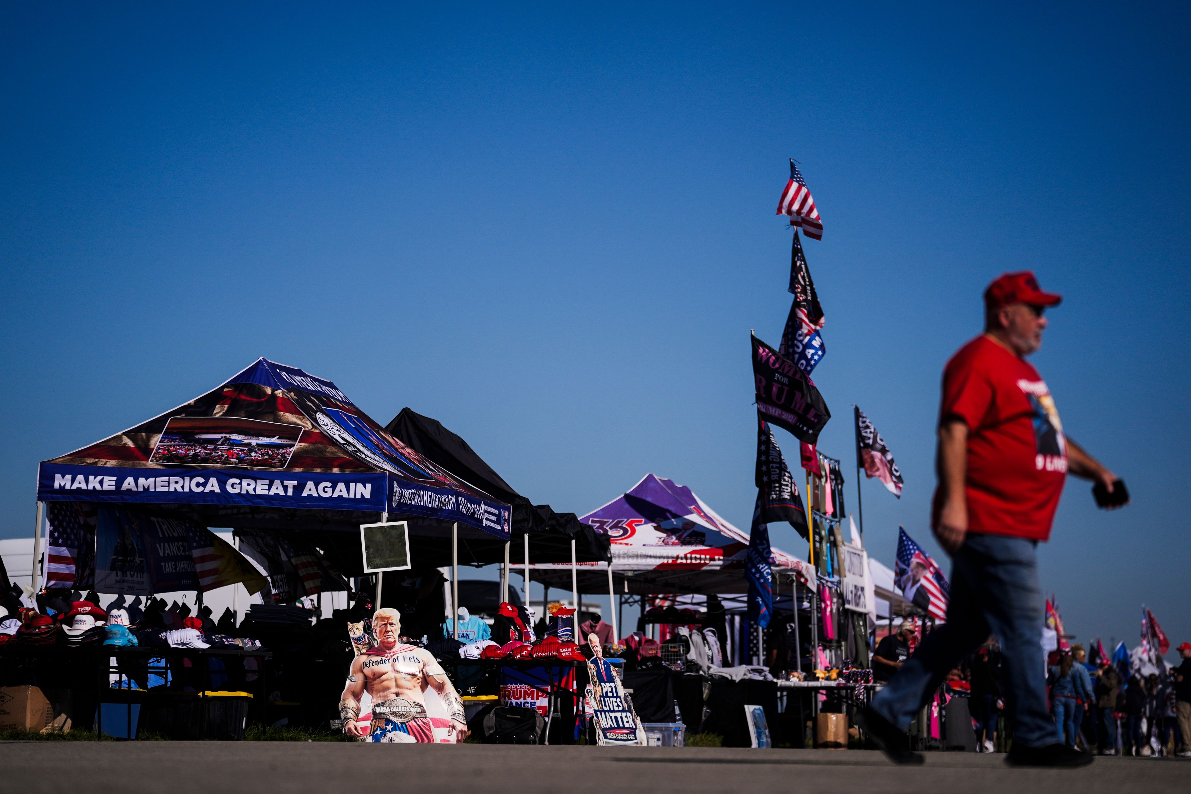 Vendors sell merchandise ahead of Republican presidential nominee former President Donald Trump's campaign rally, Saturday, Oct. 19, 2024, at Arnold Palmer Regional Airport in Latrobe, Pa. (AP Photo/Matt Rourke)