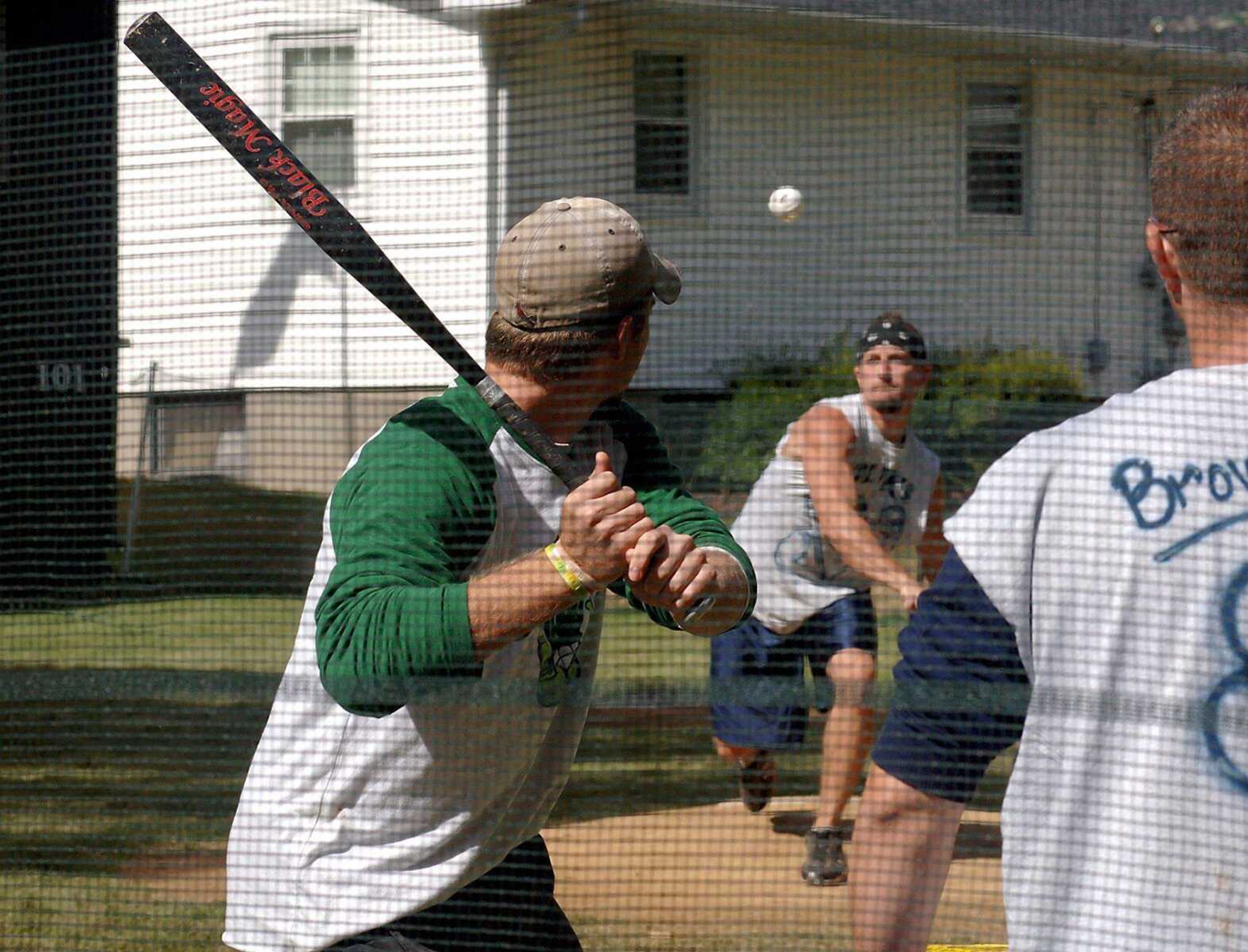 The Holiks took on the Gurken Salad's Sunday in the semi finals of the 13th annual multistate wiffle ball tournament. The Holiks came from Parsons, Kan., for the fifth year to compete in the tournament held at Sherwood Yards, a custom-made wiffleball field that Jeff Augustine has built in his parents' backyard over the years. (LAURA SIMON)