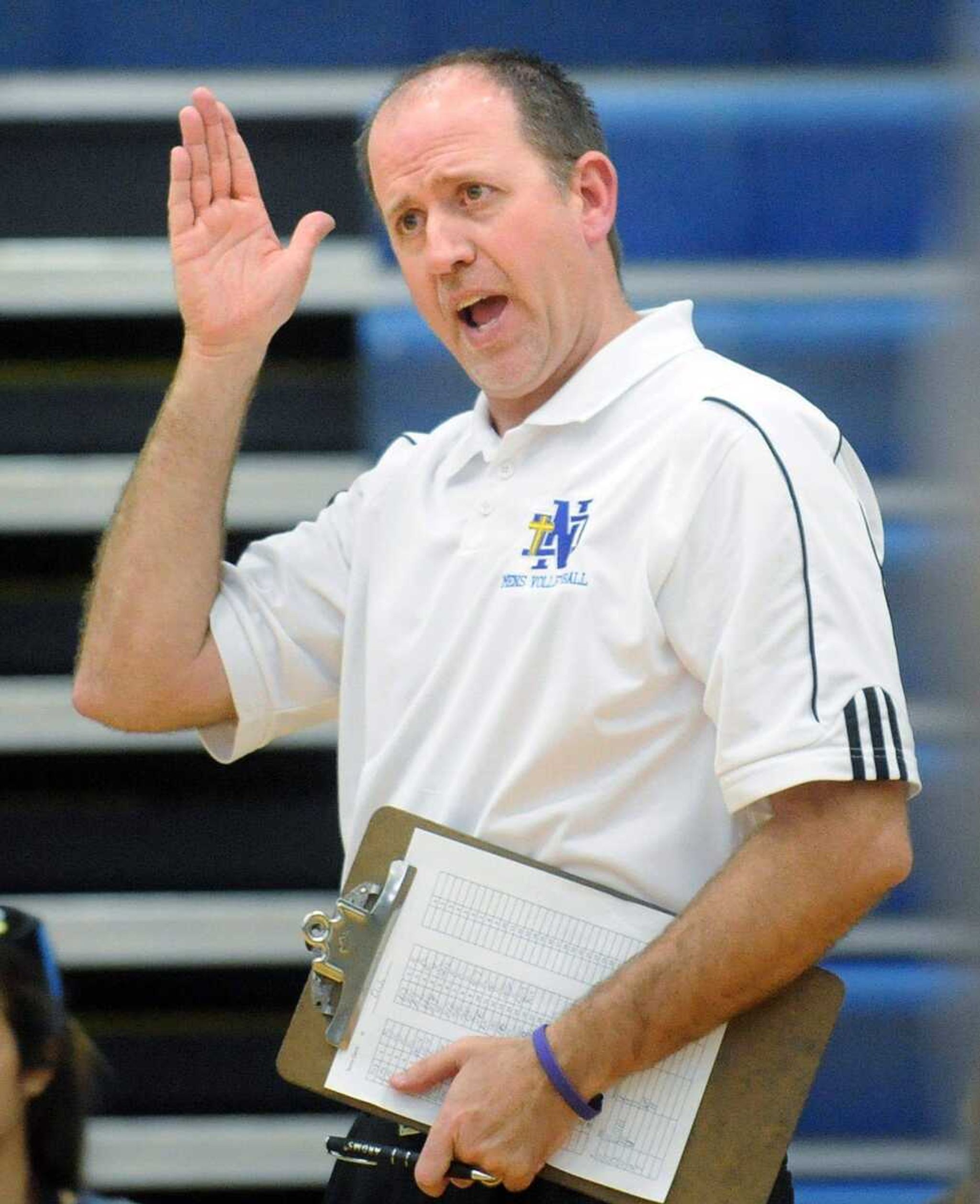 Notre Dame coach Mark Moore directs his players from the sideline during the second set.