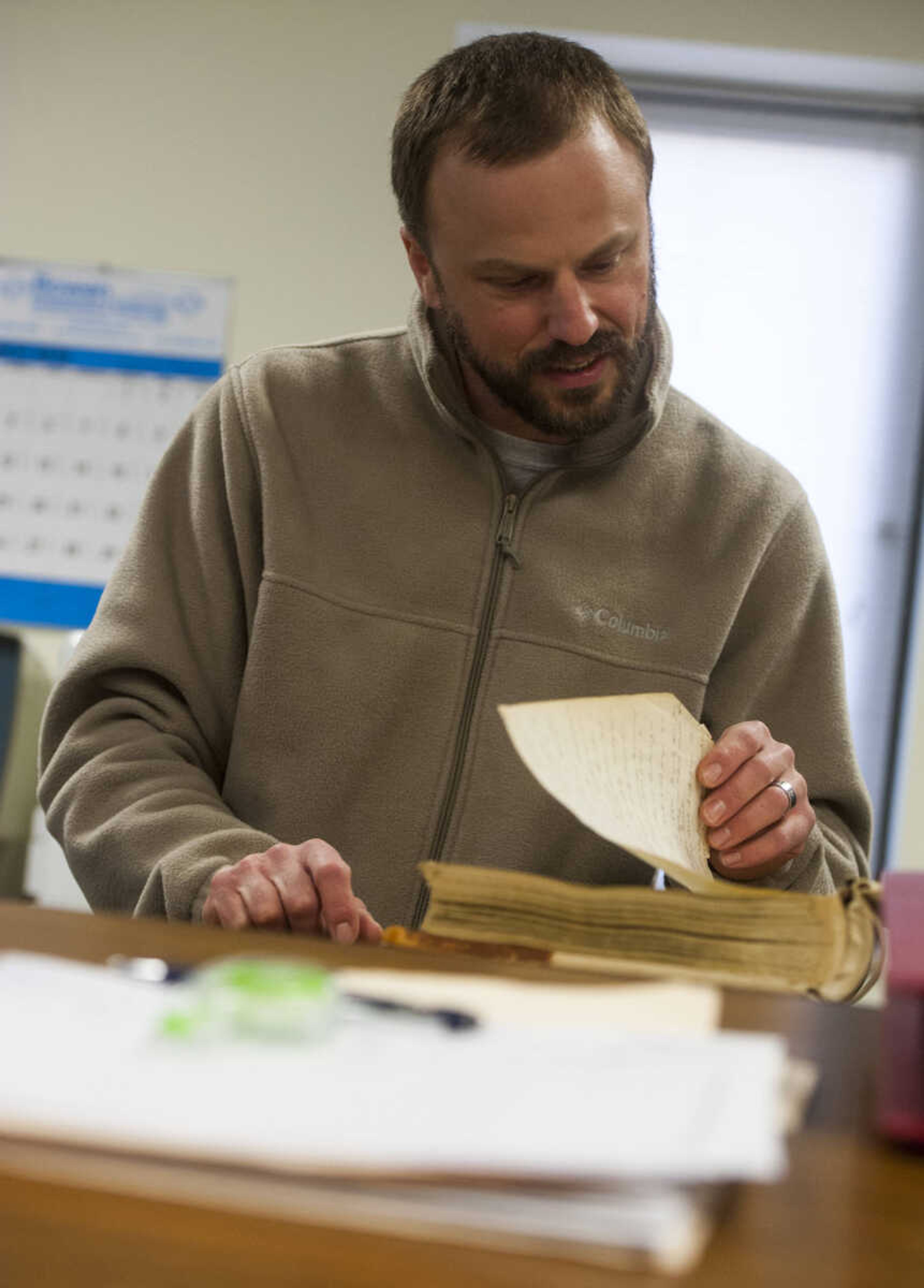 Cape Girardeau County recorder of deeds Andrew Blattner flips through the pages of an index Thursday, March 8, 2018, in the Recorder's Office at the Cape County Administration Building in Jackson.