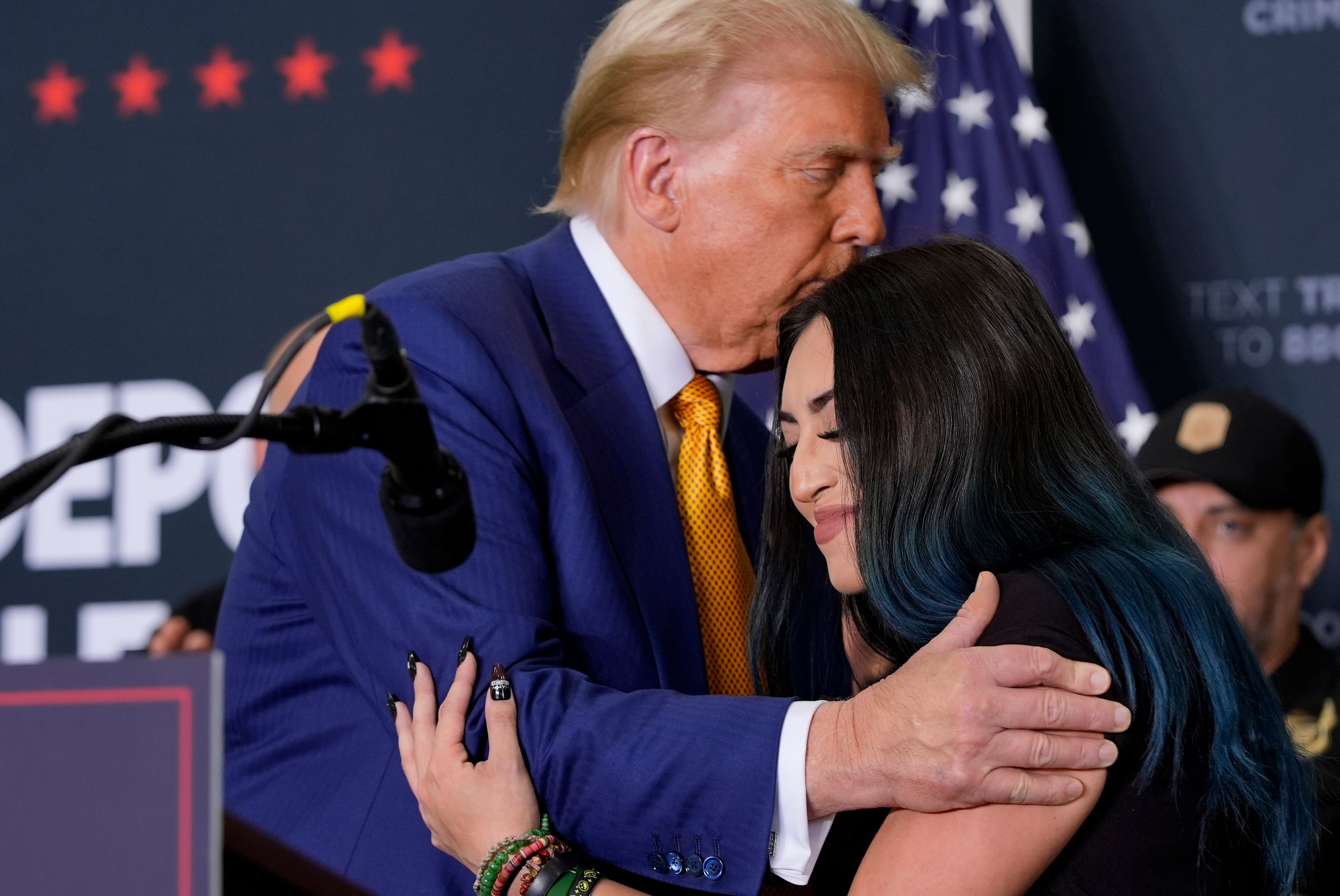 Republican presidential nominee former President Donald Trump, left, hugs Alexis Nungaray, mother of the late Jocelyn Nungaray, during a news conference at Austin-Bergstrom International Airport, Friday, Oct. 25, 2024, in Austin, Texas. (AP Photo/Alex Brandon)