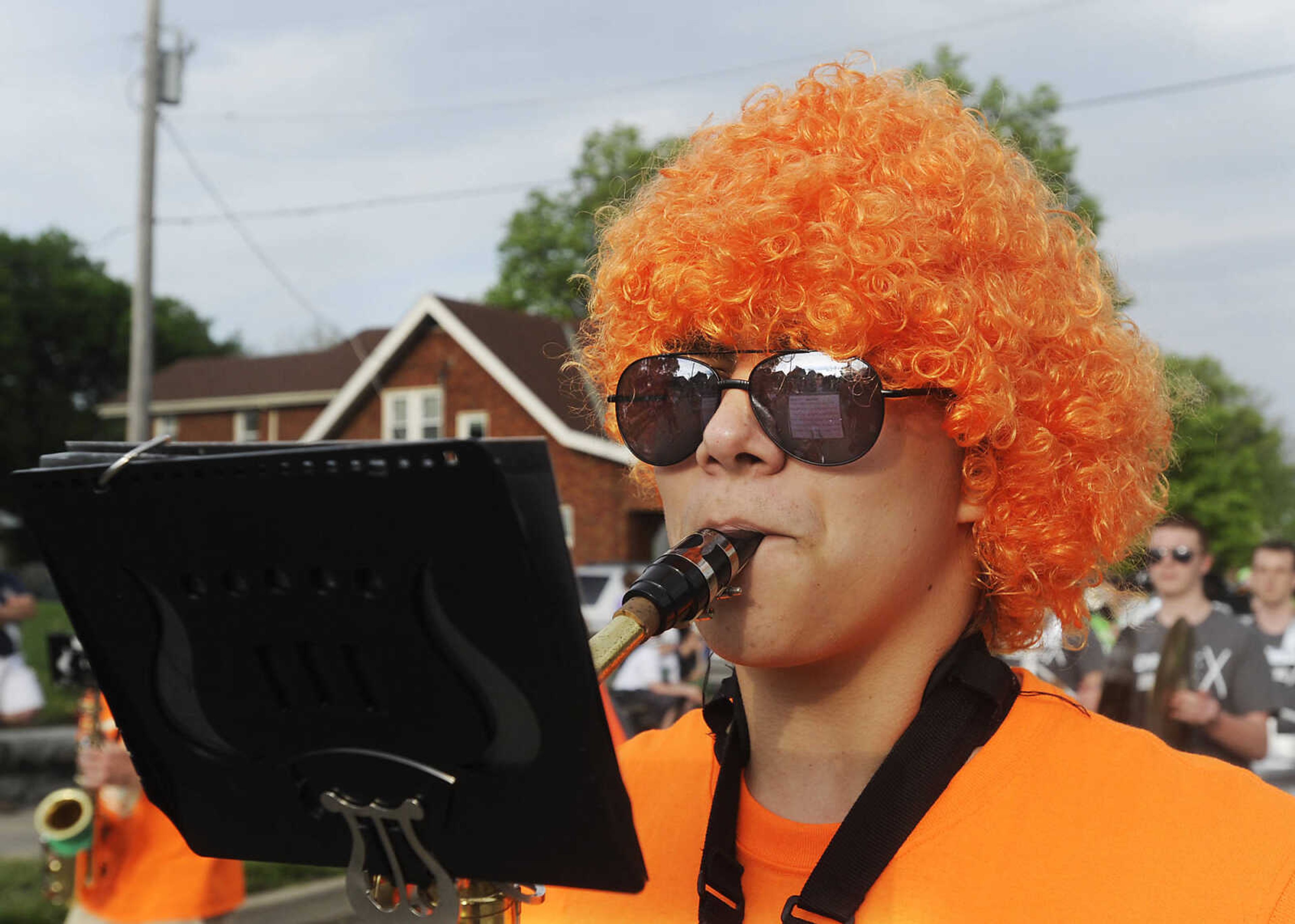 Aaron Brignau, 15, performs with the Perryville High School Marching Band during the Perryville Mayfest Parade Friday, May 10, in Perryville, Mo. This year's Mayfest theme is Peace, Love, Perryville Mayfest.