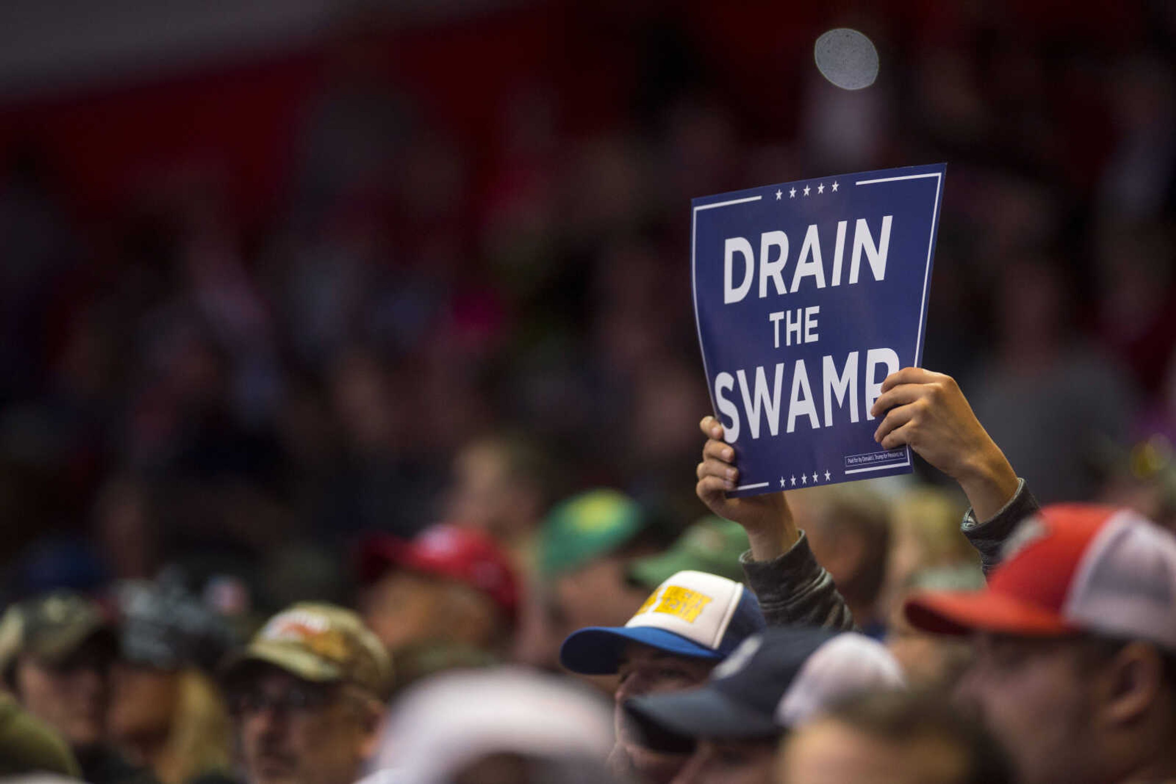 A rally-goer holds up a "Drain the Swamp" sign inside of the Show Me Center Monday, Nov. 5, 2018, in Cape Girardeau.