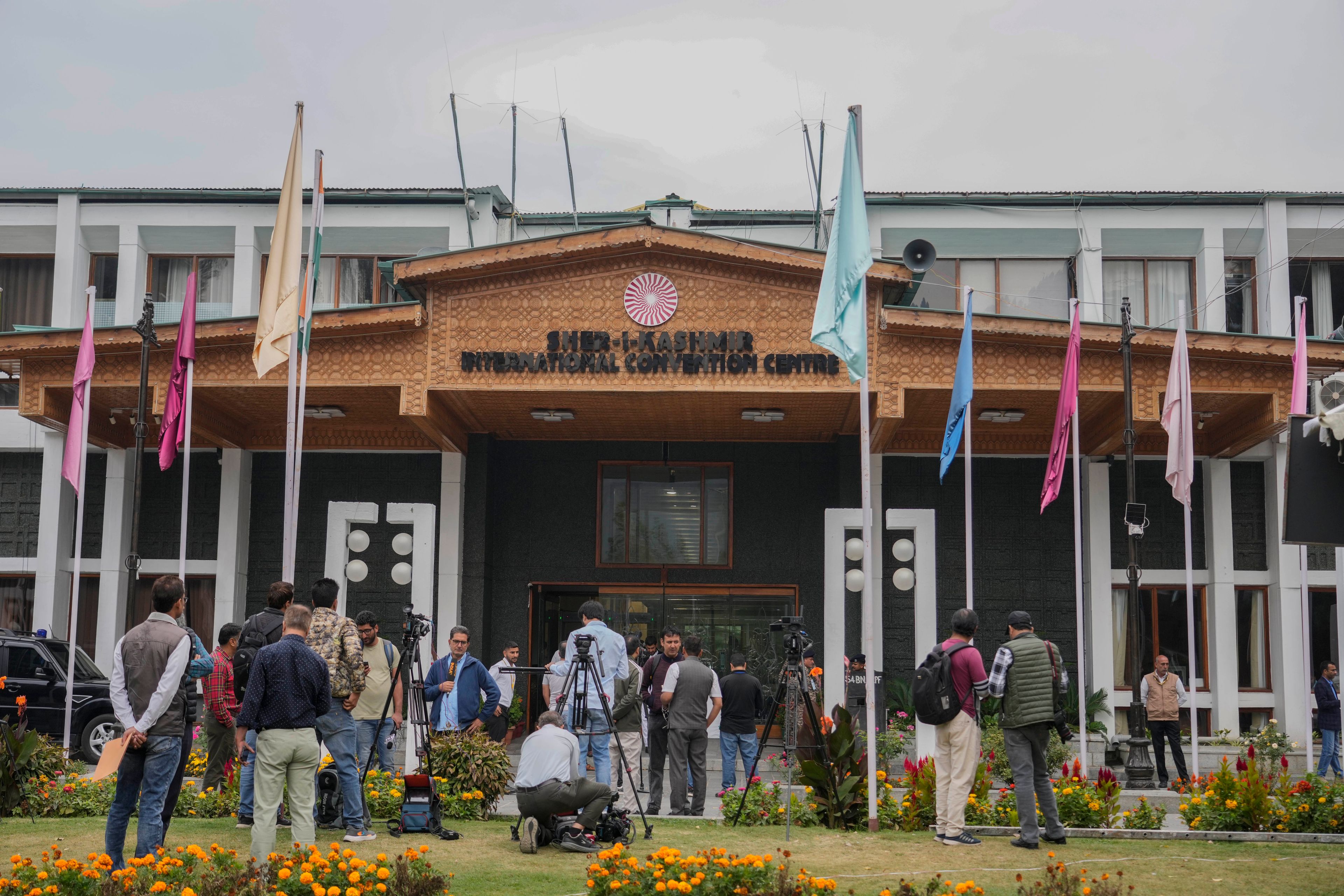 Media persons wait outside a vote counting center the recent election on the outskirts of Srinagar, Indian controlled Kashmir, Tuesday, Oct. 8, 2024. (AP Photo/Mukhtar Khan)