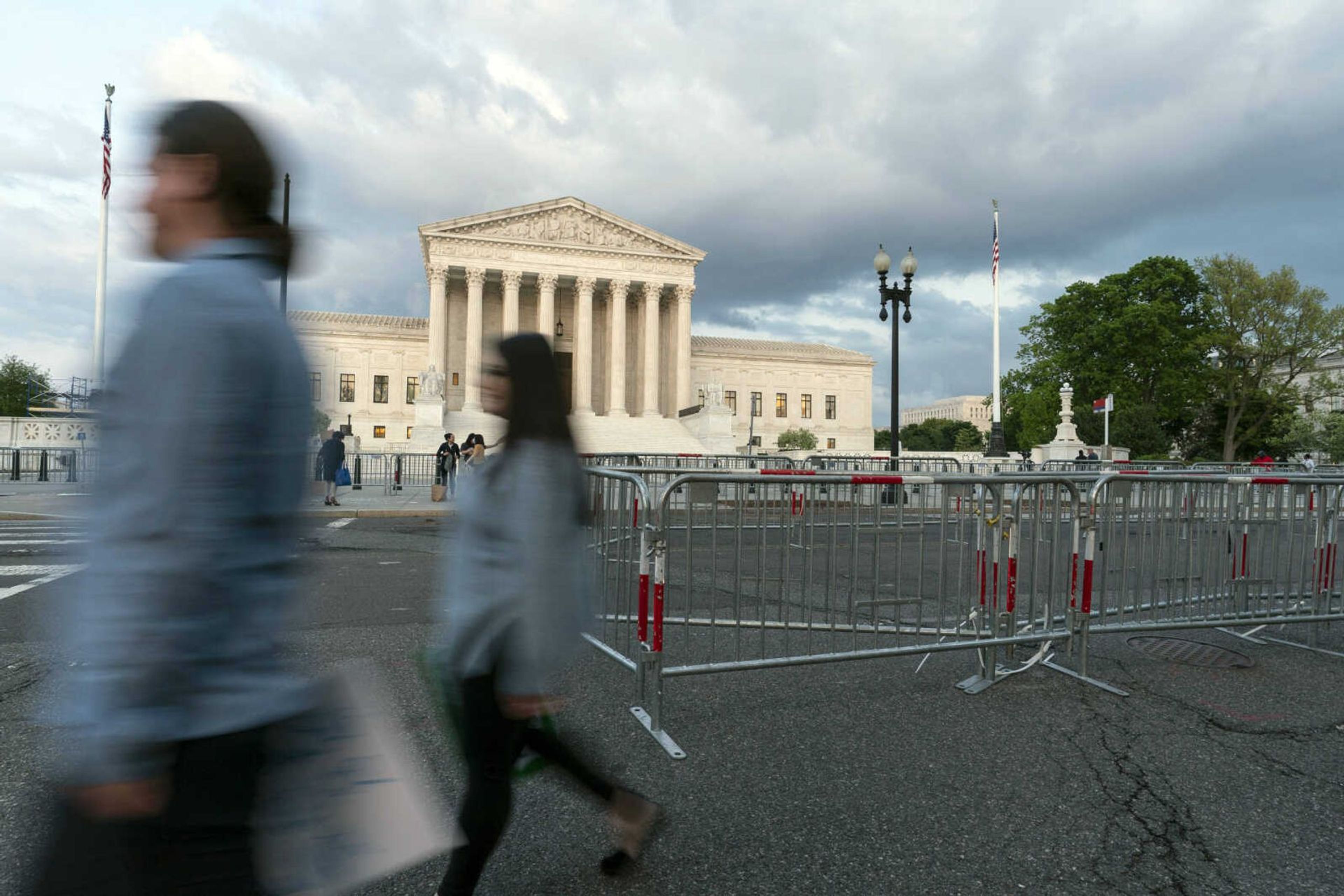 Demonstrators walk to a protest outside the U.S. Supreme Court in Washington after a draft of the Roe v. Wade reversal was leaked. The U.S. Supreme Court would overturn the landmark 1973 case that legalized abortion nationwide.