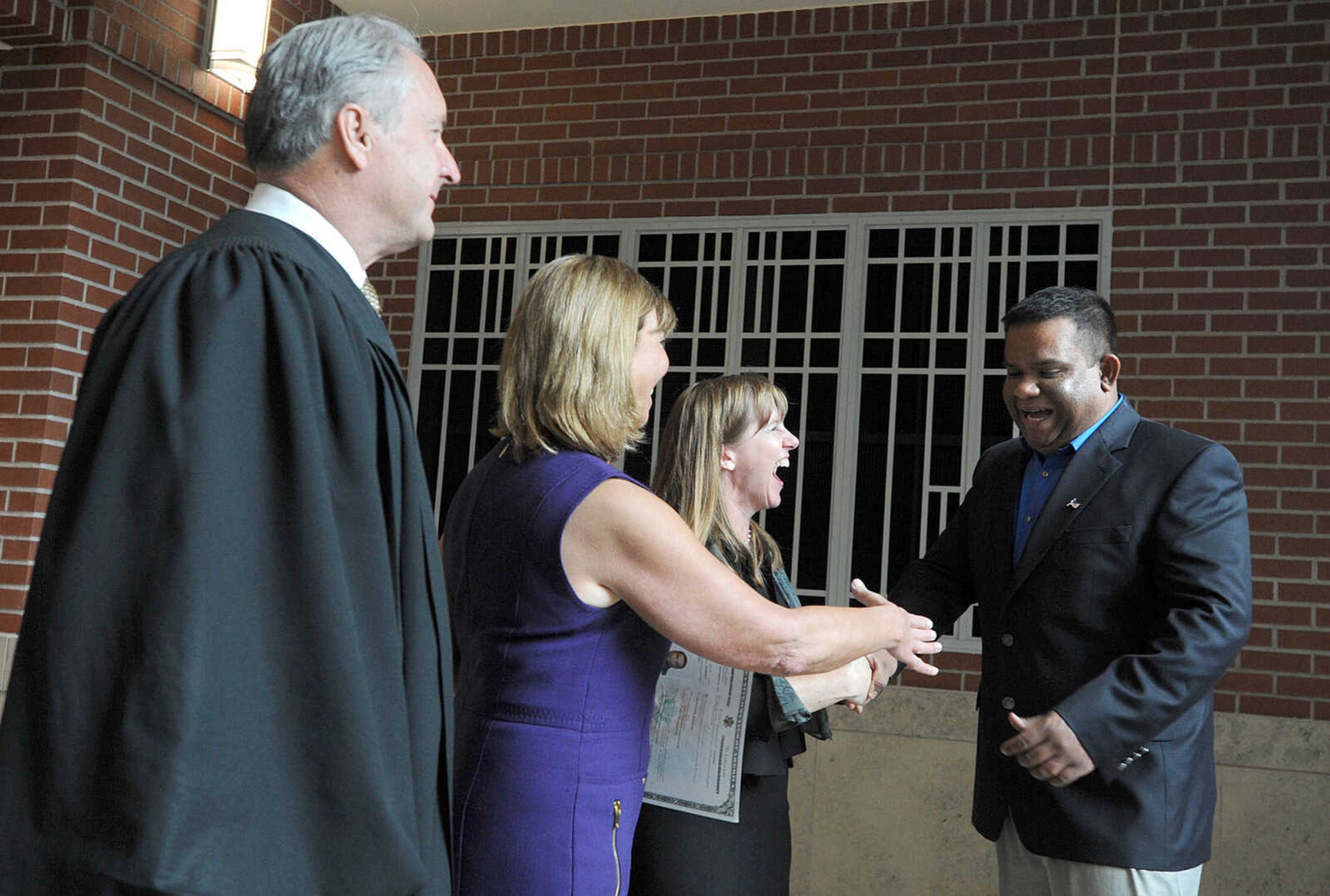 LAURA SIMON ~ lsimon@semissourian.com
Federal District Judge Stephen N. Limbaugh, Jr., Rep. Jo Ann Emerson and Assistant U.S. Attorney and Nationalization Examiner Abbie Crites-Leoni congratulate Amila Panchala Ramanayake on his U.S. citizenship Tuesday, May 1, 2012 at the Rush Hudson Limbaugh, Sr. U.S. Courthouse in Cape Girardeau. Seventeen petitioners became citizens of the United States of America during Tuesday's naturalization ceremony.