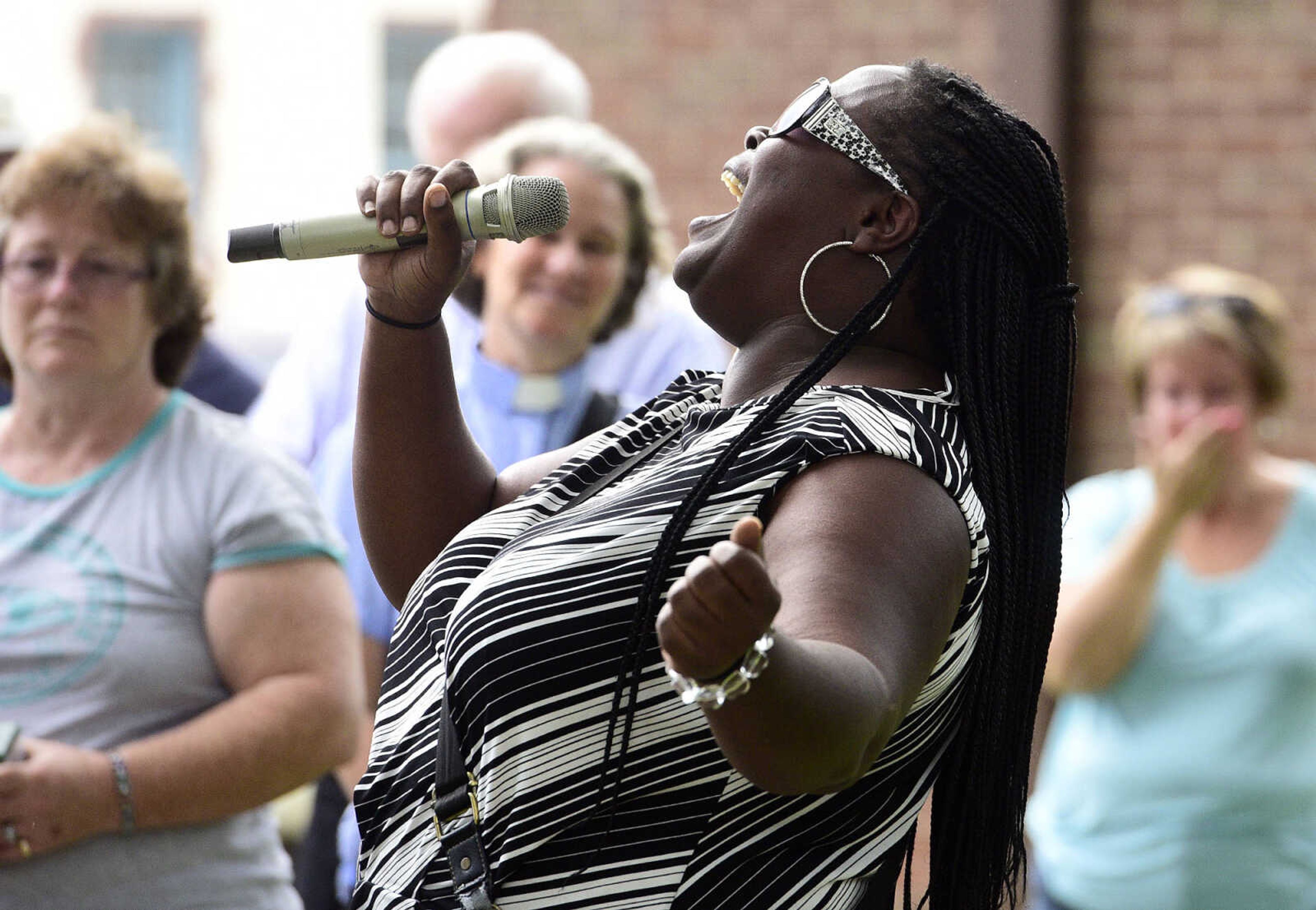 Ramona Bailey sings "It is Well" during a Love, Not Hate rally on Sunday evening, Aug. 13, 2017, at Ivers Square in Cape Girardeau.