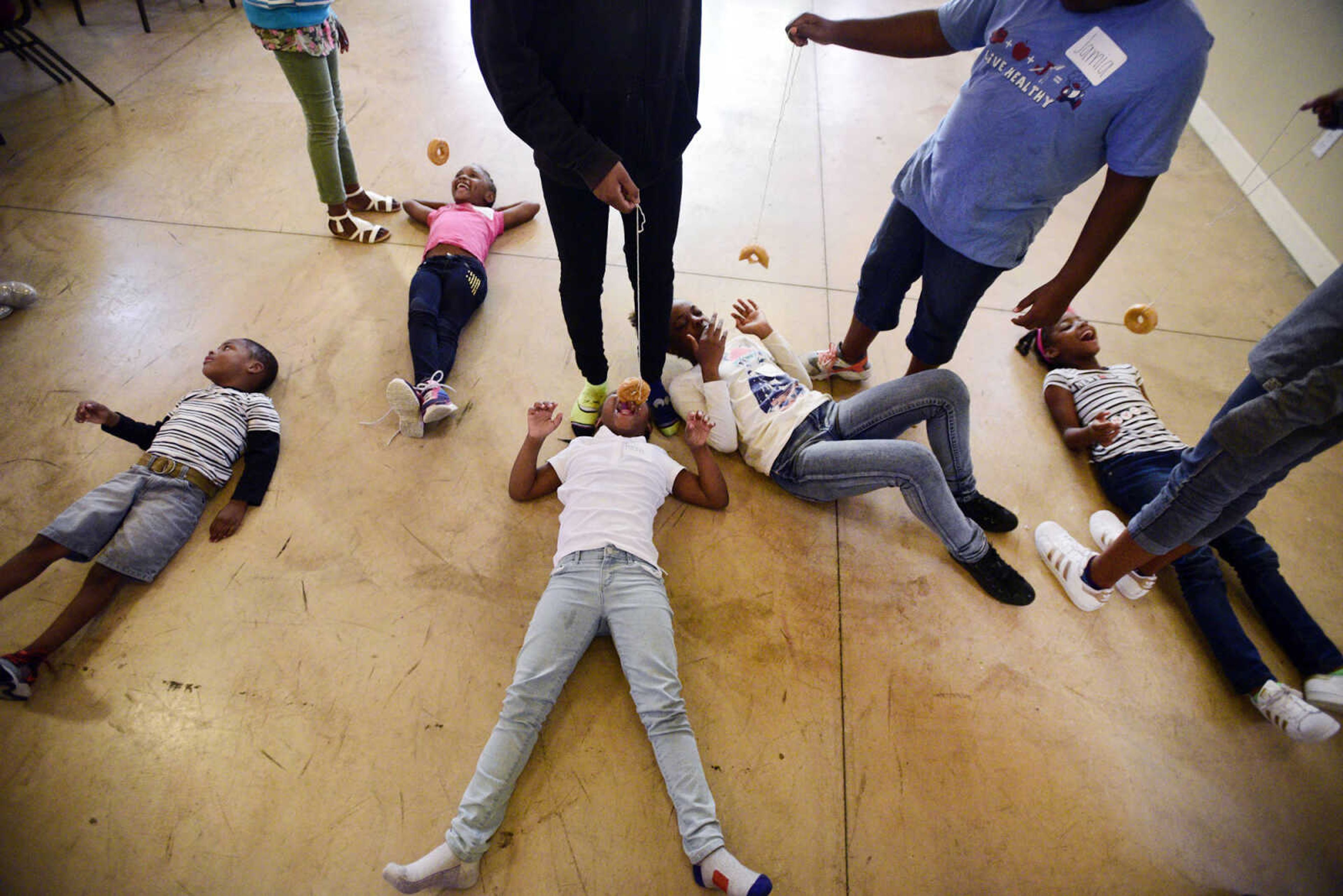 Students play a donut game on Monday, Aug. 14, 2017, during the Salvation Army's after school program at The Bridge Outreach Center in Cape Girardeau. The after school program runs throughout the school year.